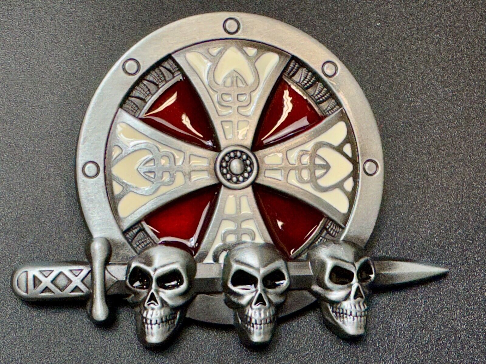 Three skulls with sword through heads on Iron Cross round NOS belt buckle