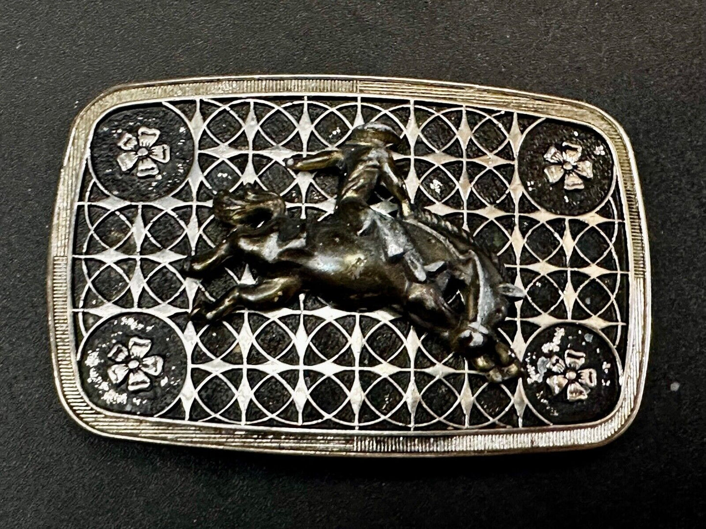 Vintage Cowboy on Saddle Bronc Western belt buckle with mesh pattern background