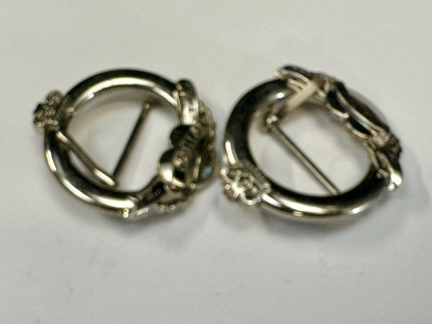 Two Kathy Van Zeeland signed silver tone round heart accented belt buckles