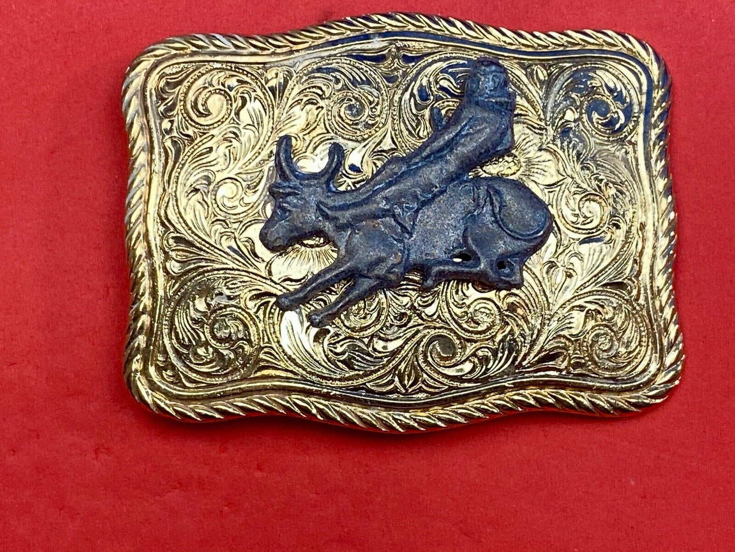 bull riding rodeo cowboy on beautiful gold color flower swirl belt buckle 