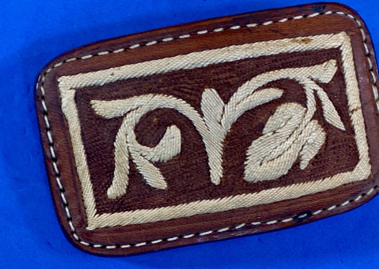 Vintage embroidered flower theme on brown leather belt buckle
