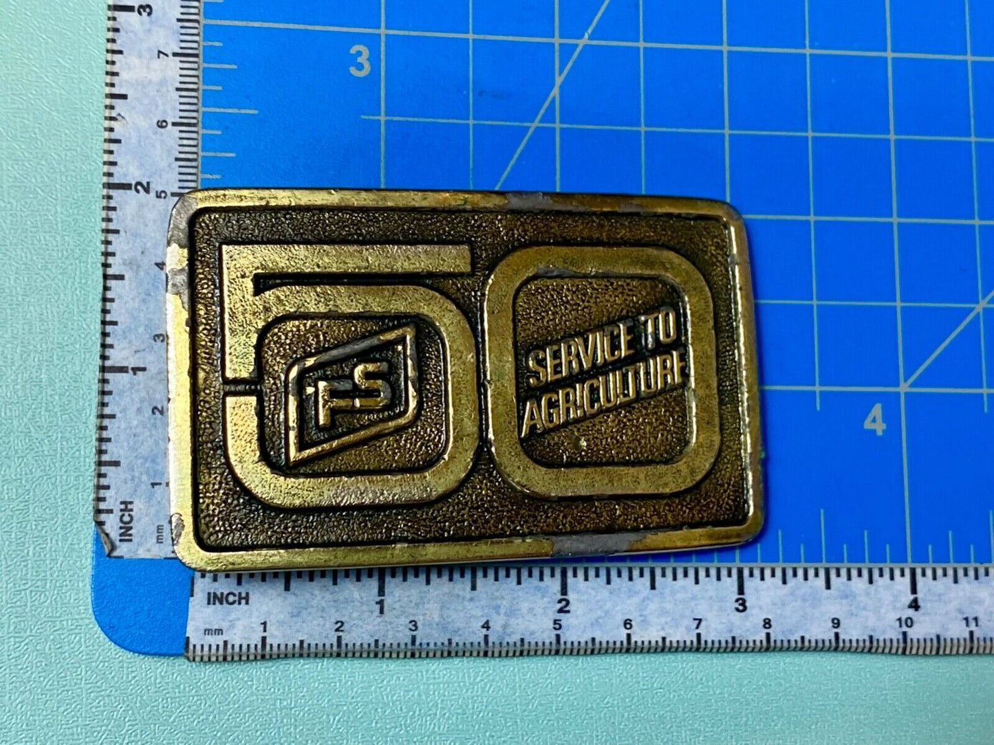 50 years, Farm Service to Agriculture belt buckle by Wyoming Studio Art works
