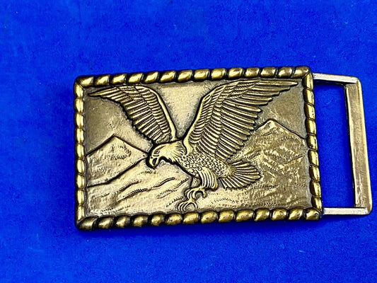 Vintage flying, hunting, fishing American eagle belt buckle with western boarder