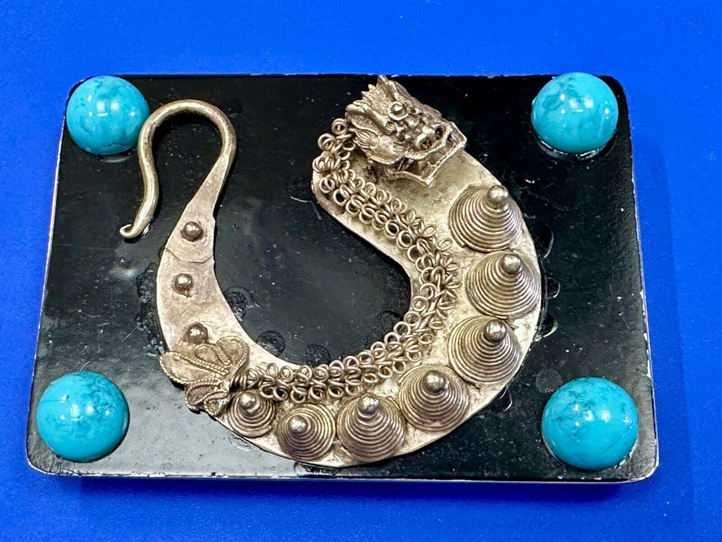 Artisan Dragon theme rectangular belt buckle with turquoise colored corner accts
