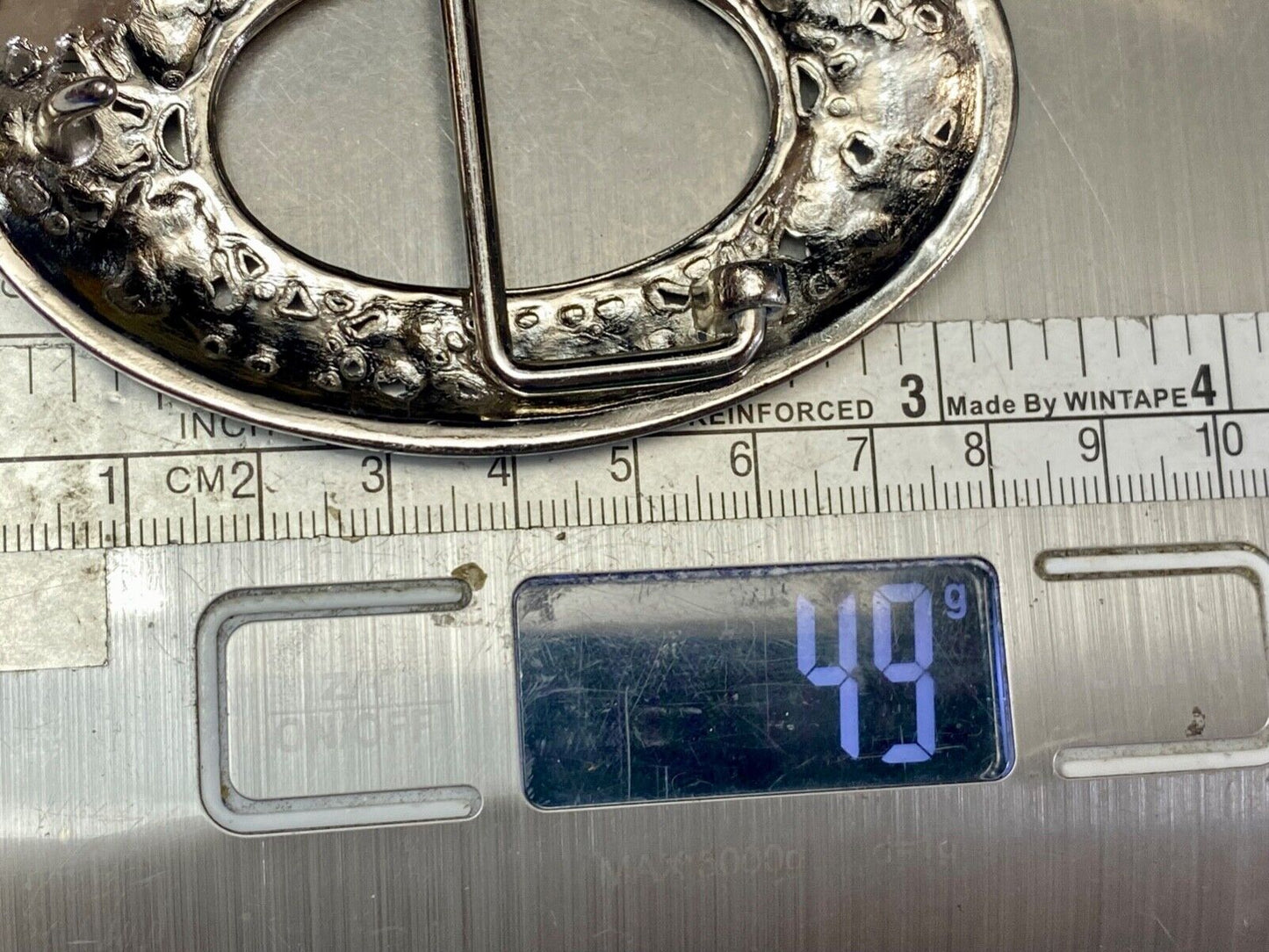 Unique blue rhinestone accented oval see though silver tone belt buckle