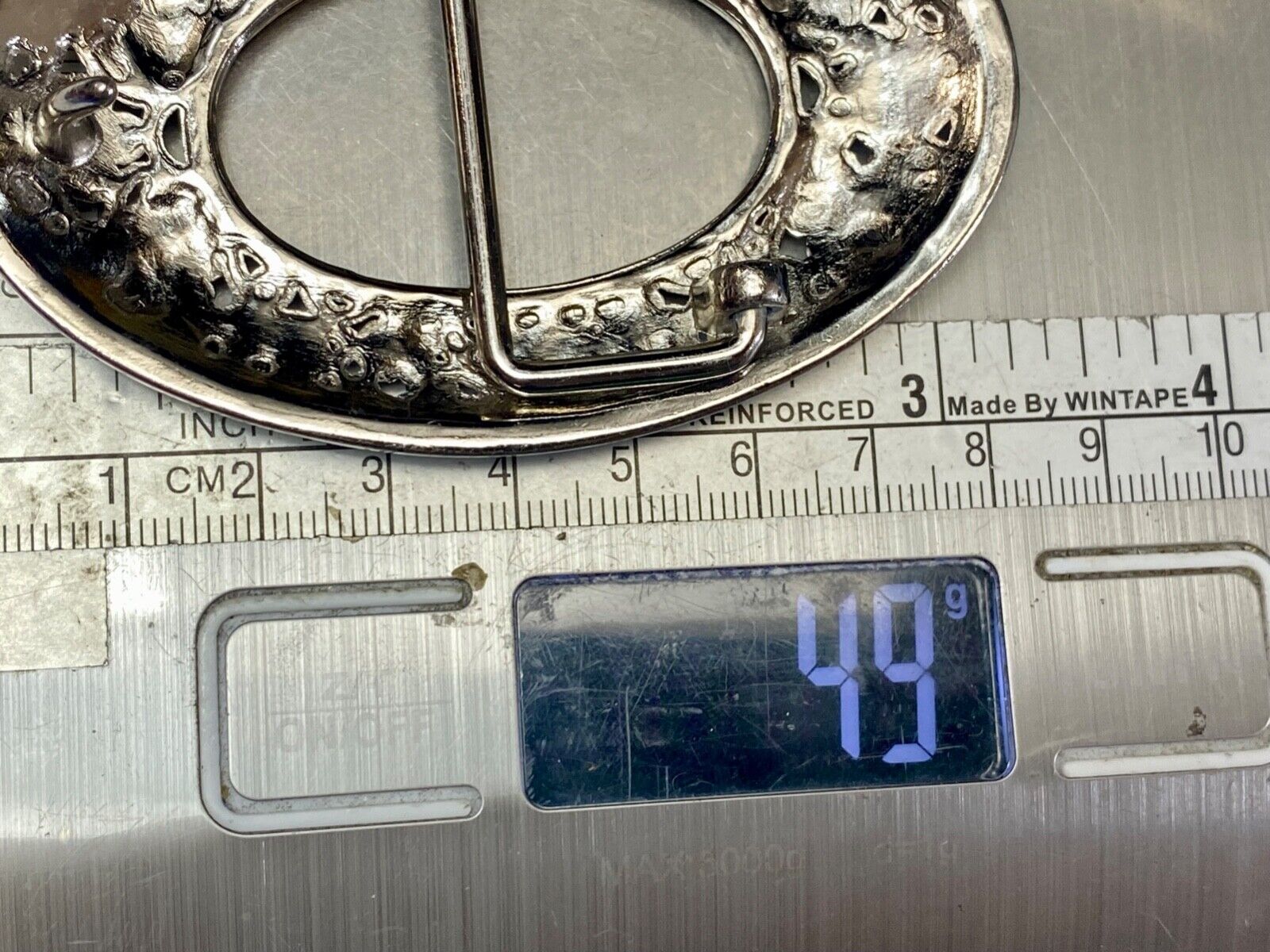 Unique blue rhinestone accented oval see though silver tone belt buckle