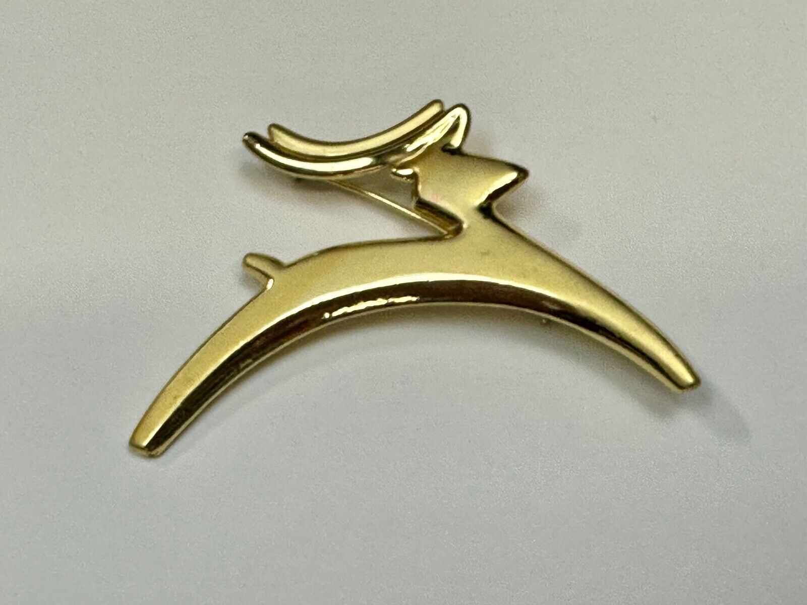 Abstract gold tone running deer - Vintage Christmas Holliday Brooch by AJC