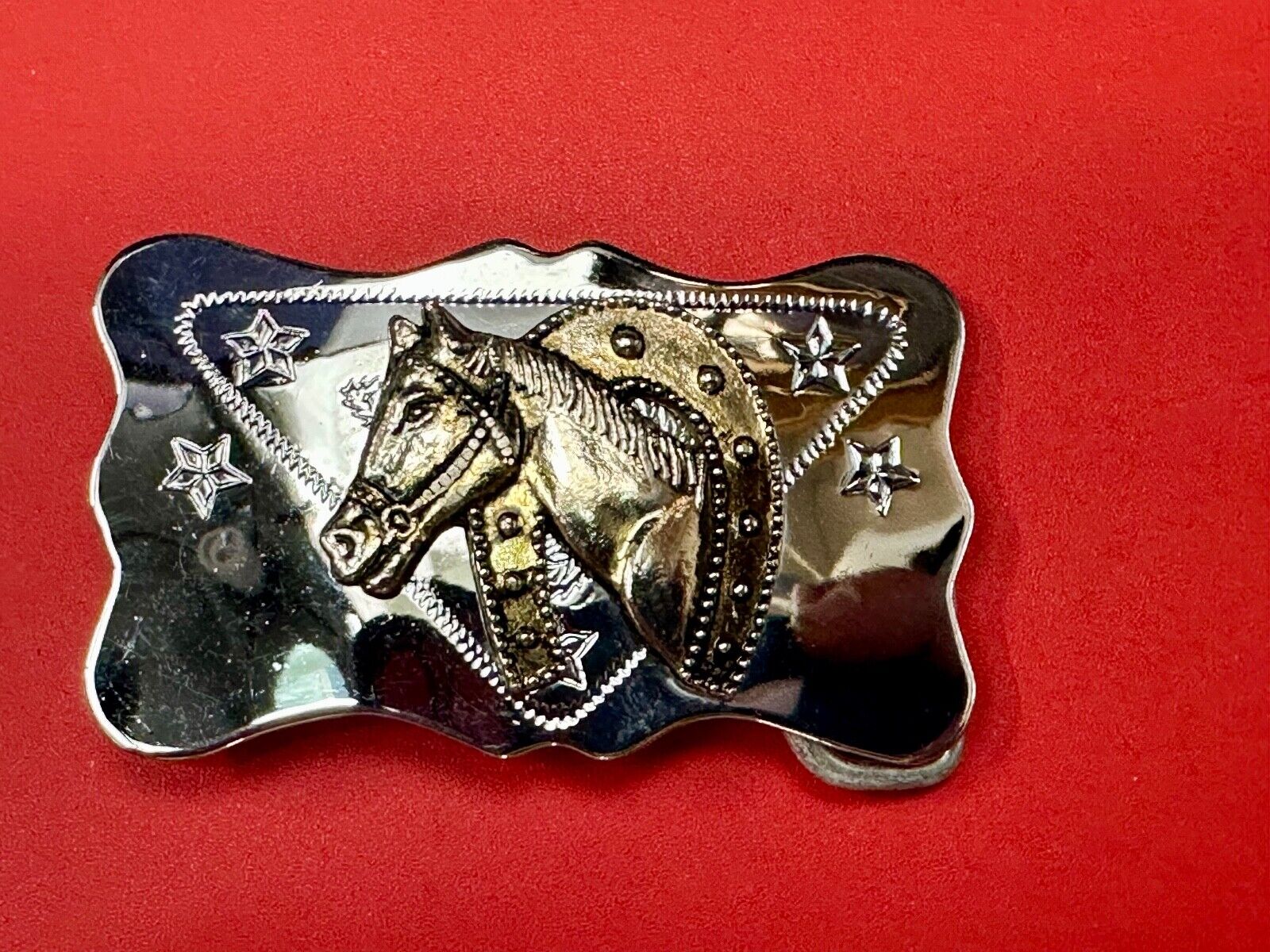 Vintage horse head through lucky horseshoe on reflective western belt buckle