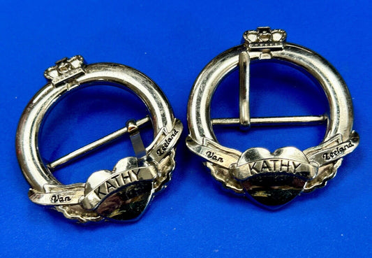 Two Kathy Van Zeeland signed silver tone round heart accented belt buckles