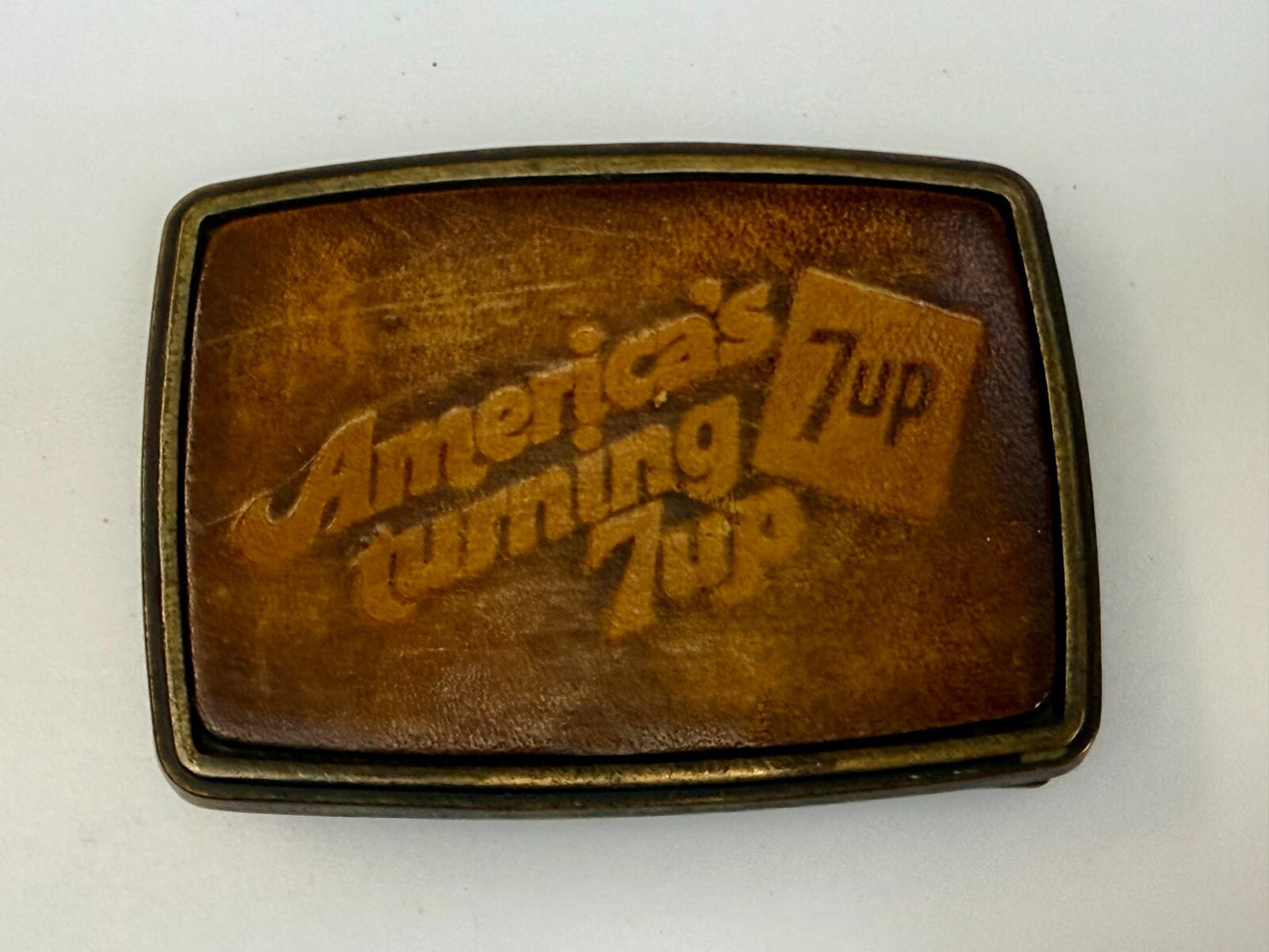 America's Turning 7up Embossed Leather on Metal Advertising Promo Belt Buckle