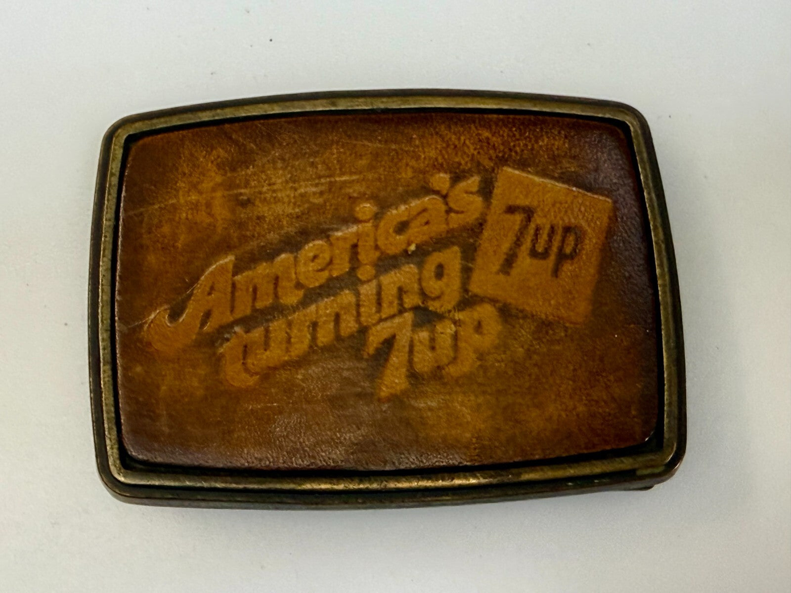 America's Turning 7up Embossed Leather on Metal Advertising Promo Belt Buckle