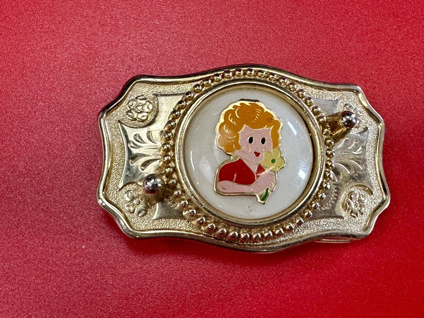 Adorable red headed girl with flower as centerpiece on western belt buckle