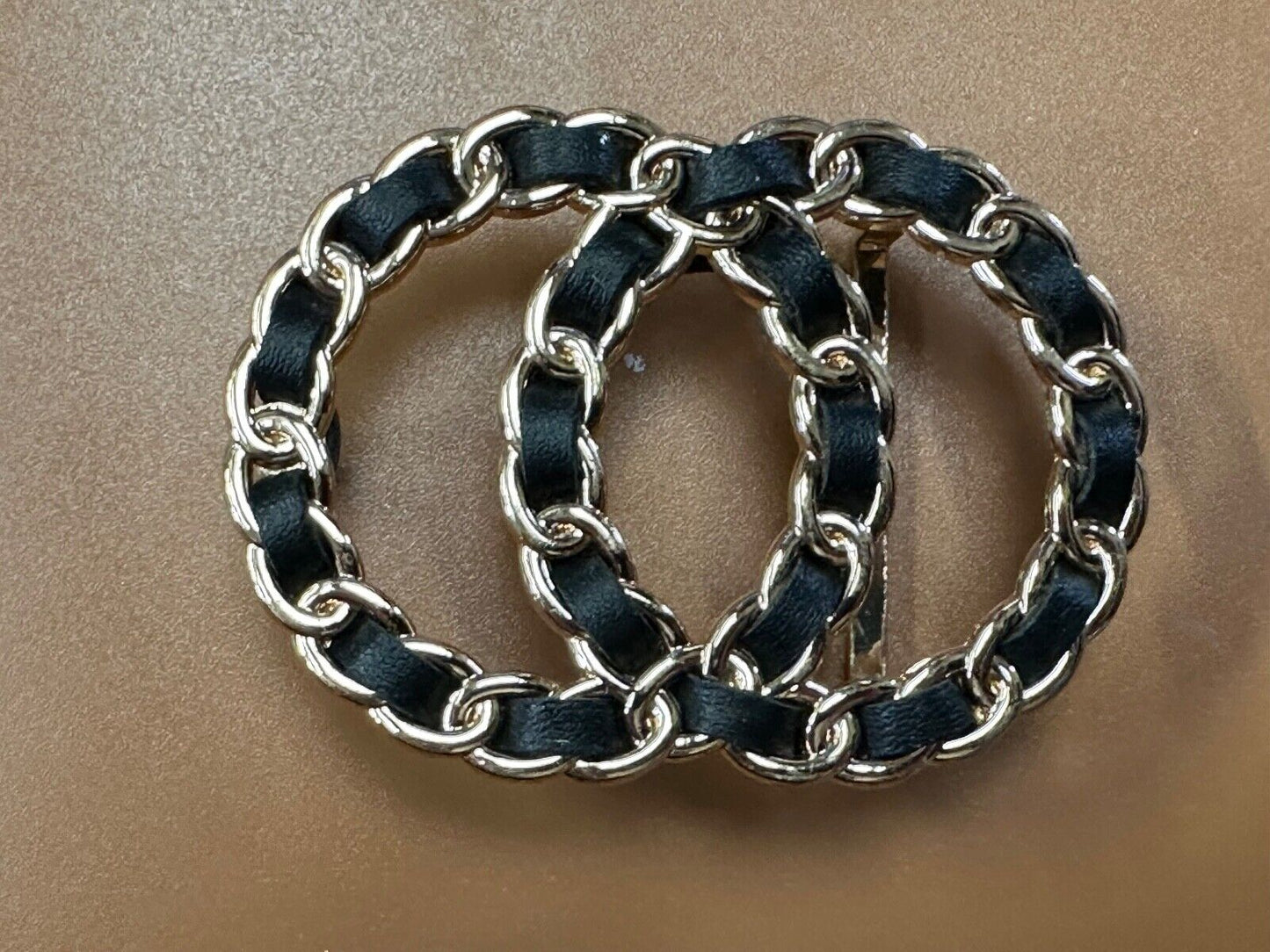 Two gold tone Overlapping Circle's with black ribbon through-out belt buckle