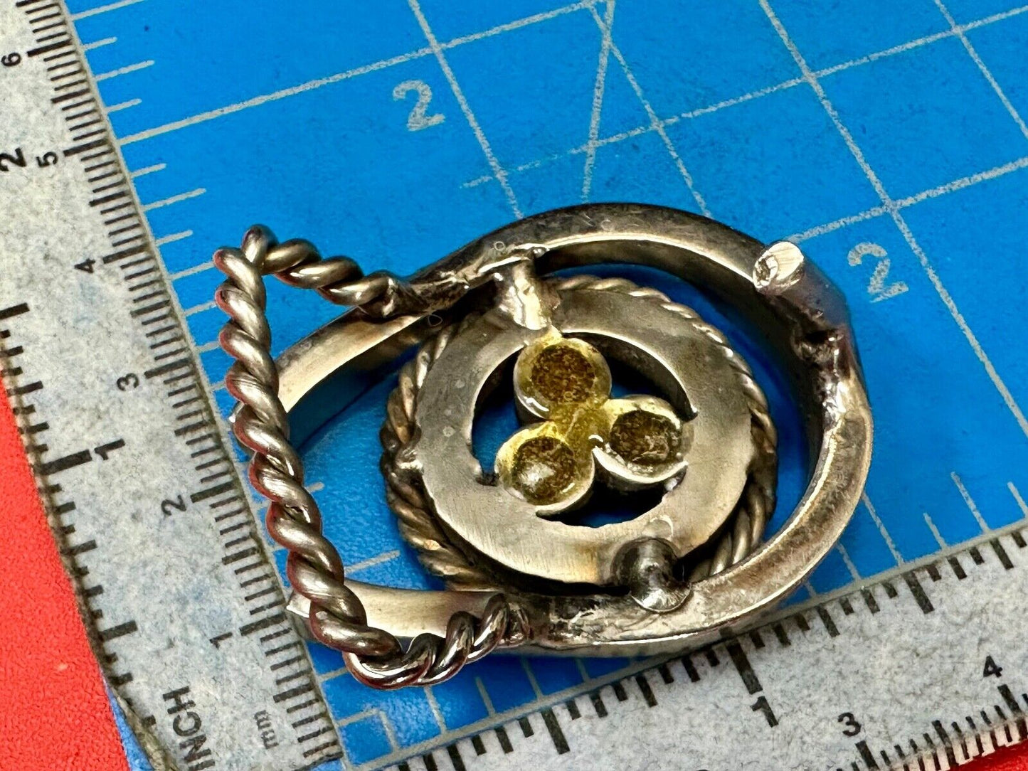 artisan circle pattern rope centerpiece red dots horseshoe shaped belt buckle