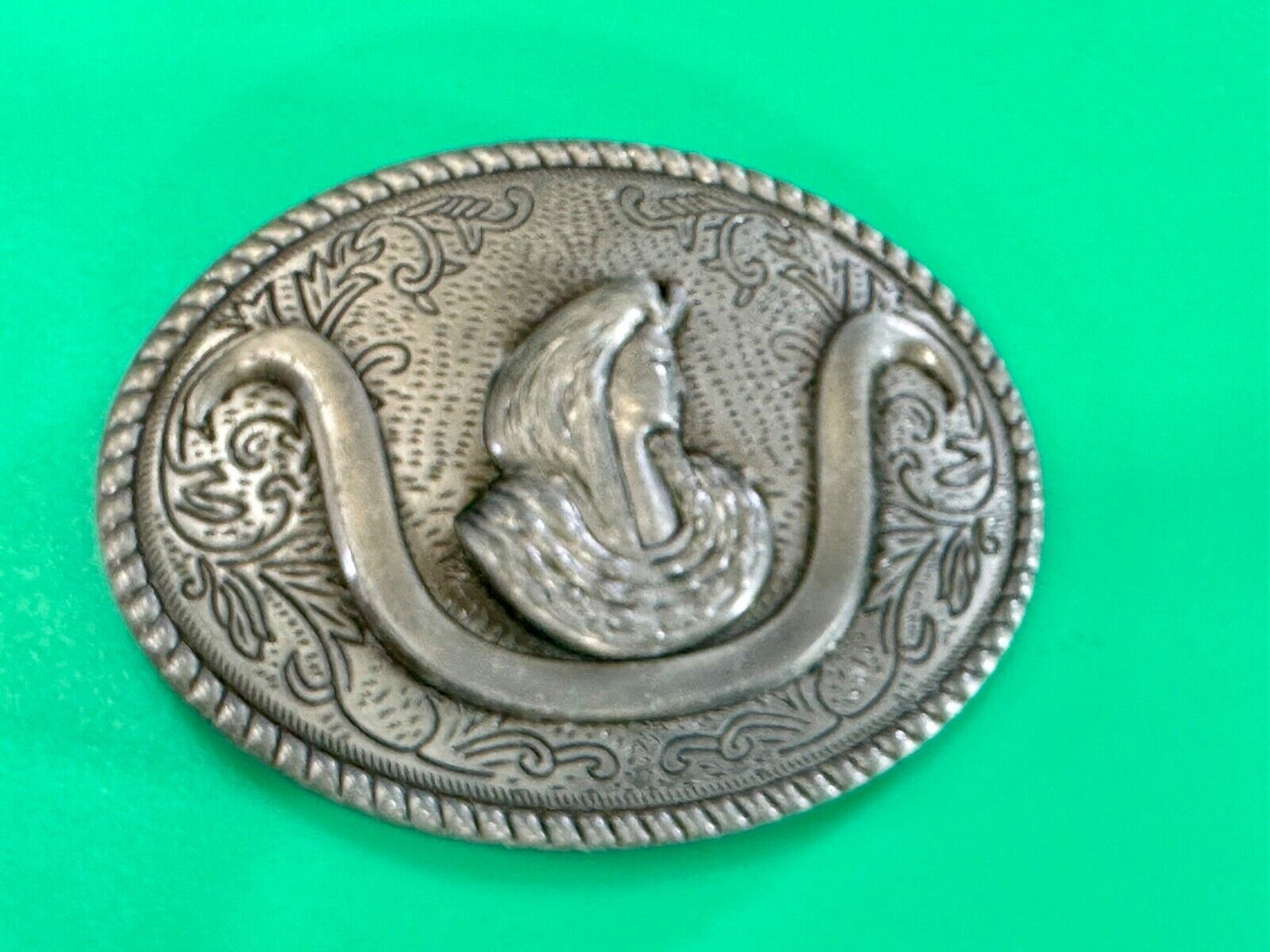 unknown to me!   Man with long hair - longhorn wester belt buckle