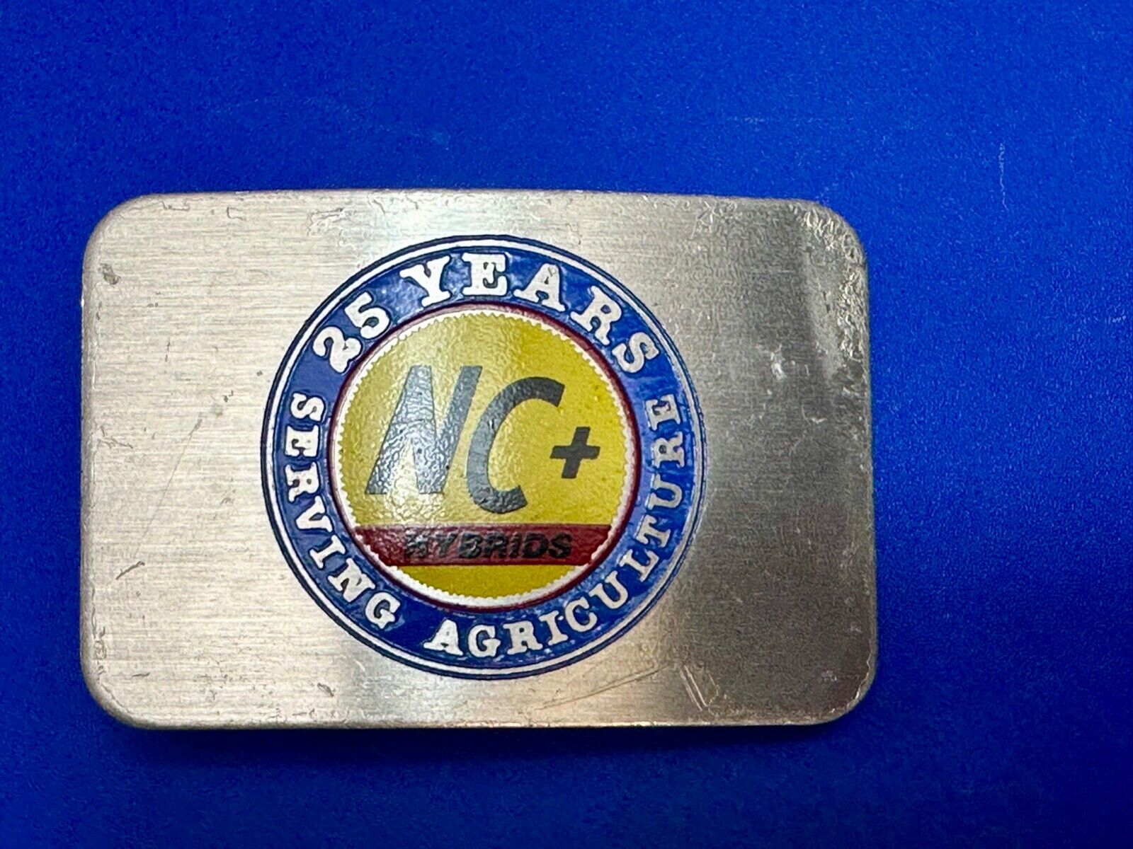 25 years serving agriculture - NC+ Hybrids Farmers Agriculture belt buckle