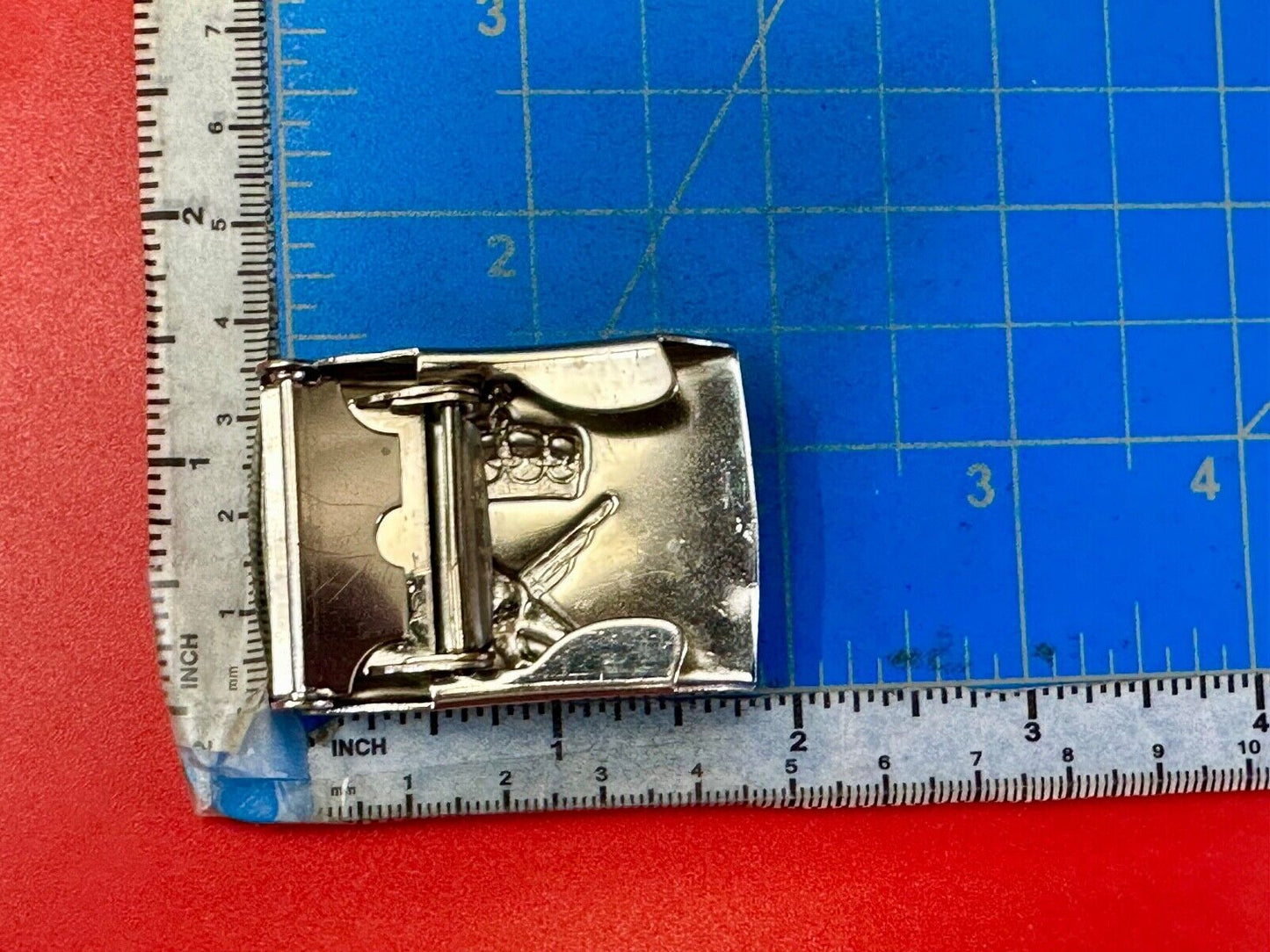 unknown to me!   dress style silver tone crown X crest? stamped belt buckle