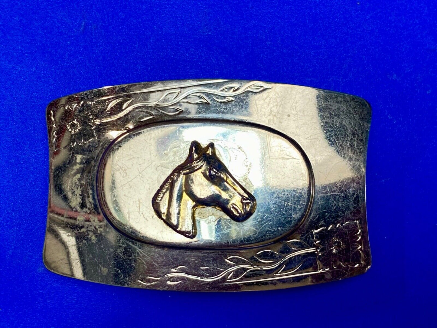 Vintage horse head on western belt buckle