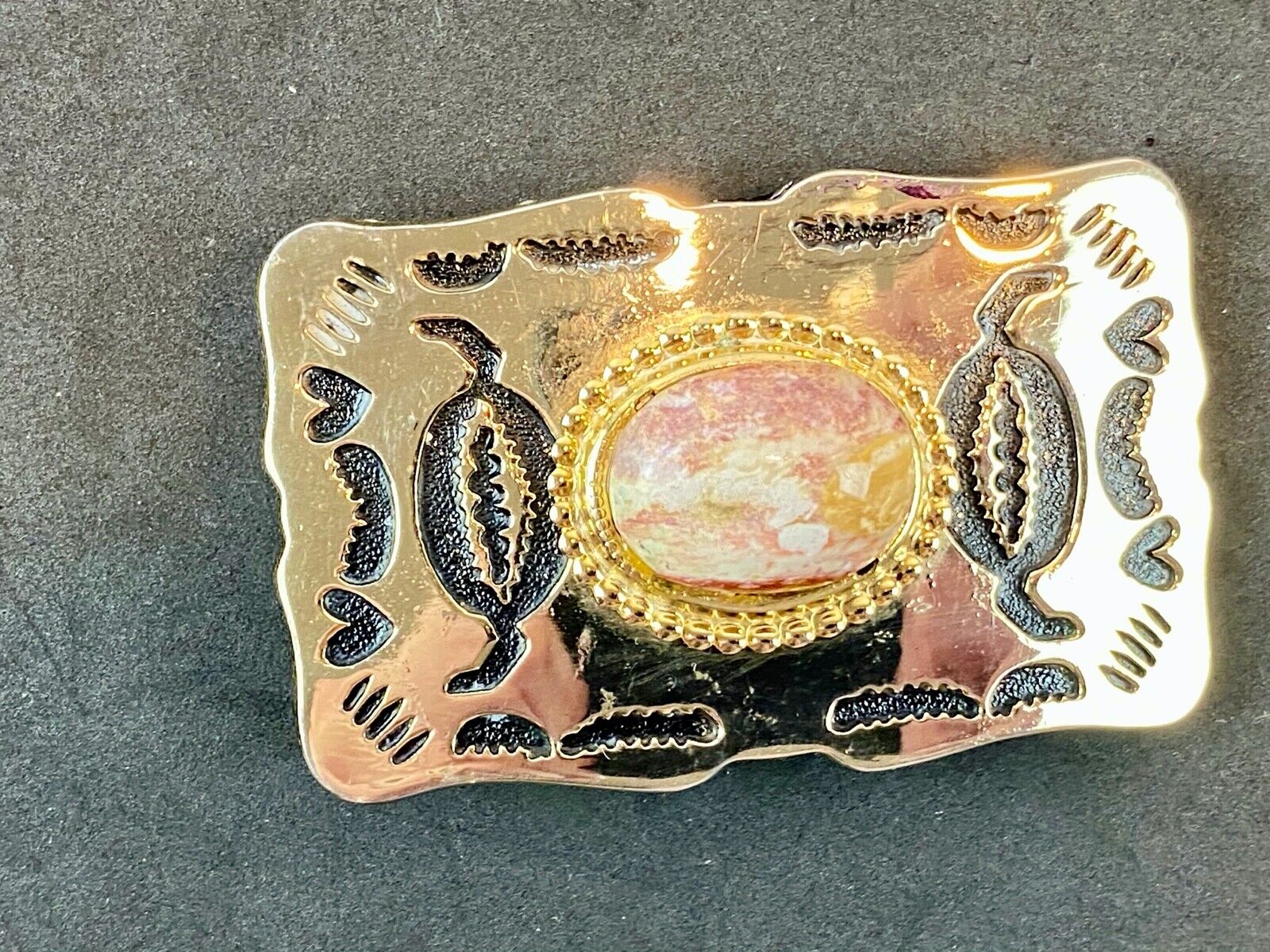 unknown multi layered colored stone as centerpiece in western belt buckle