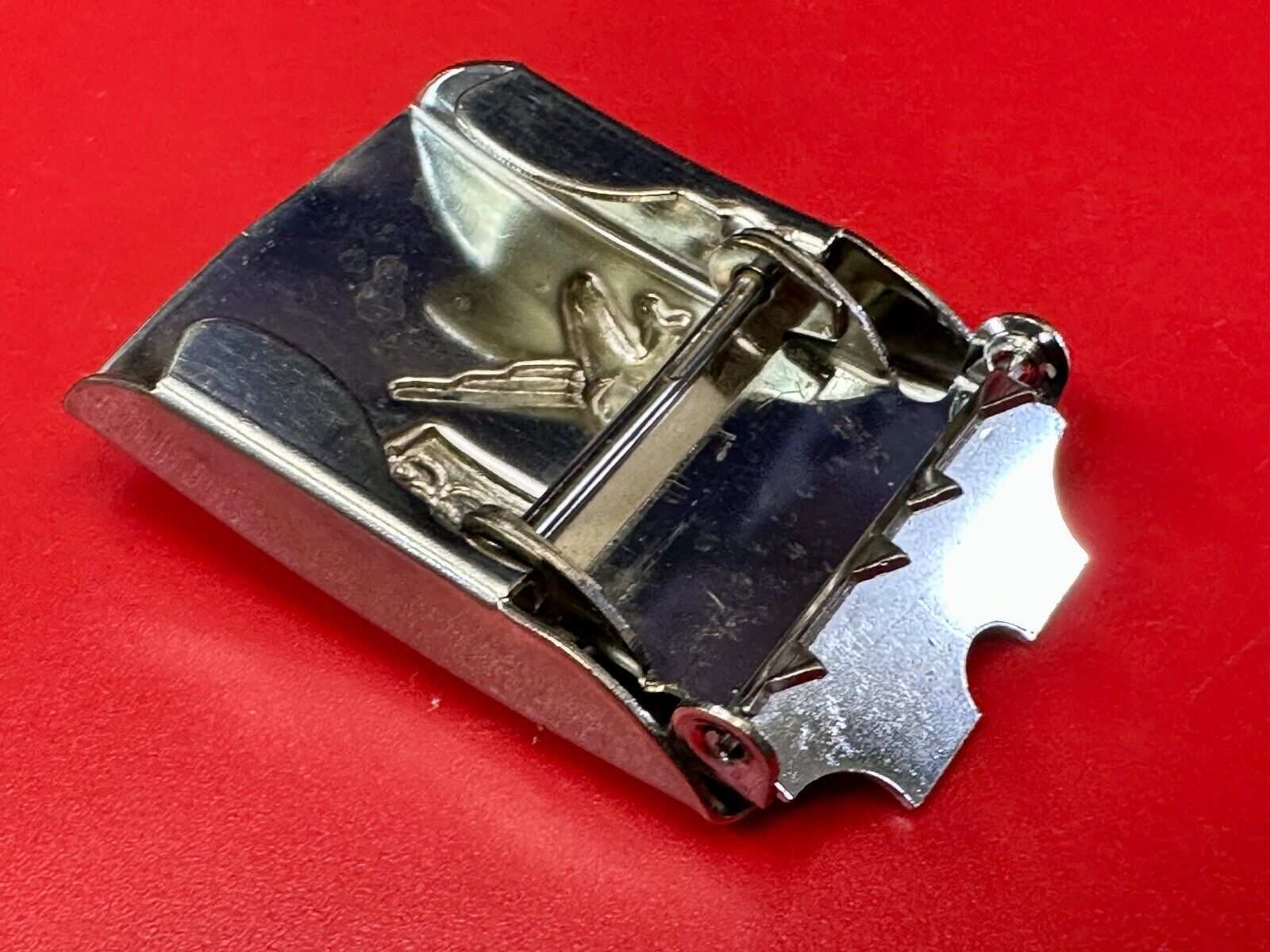 unknown to me!   dress style silver tone crown X crest? stamped belt buckle