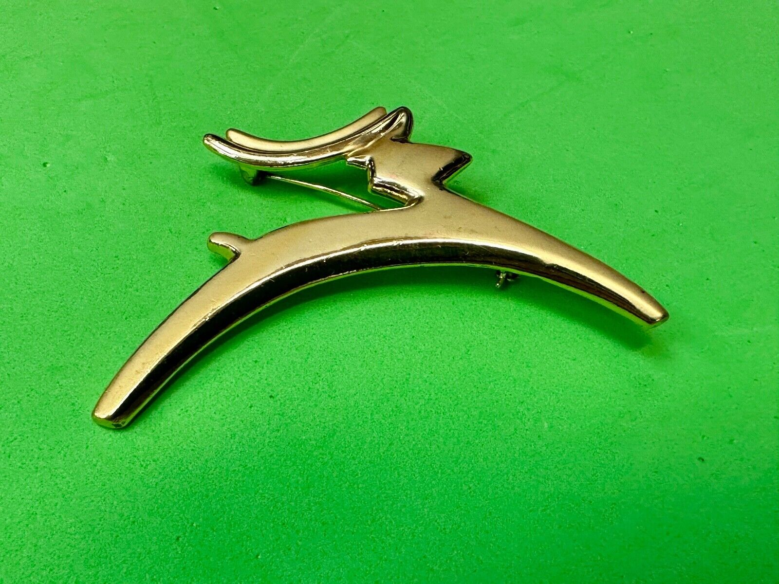 Abstract gold tone running deer - Vintage Christmas Holliday Brooch by AJC