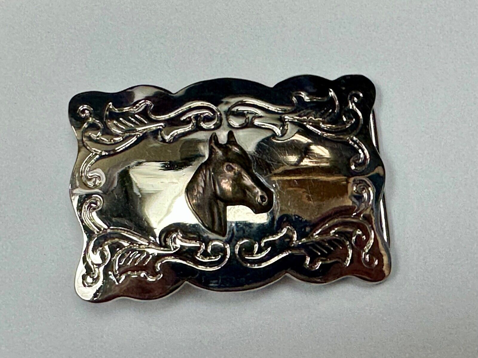 Vintage horse head centered on western rectangular two tone belt buckle