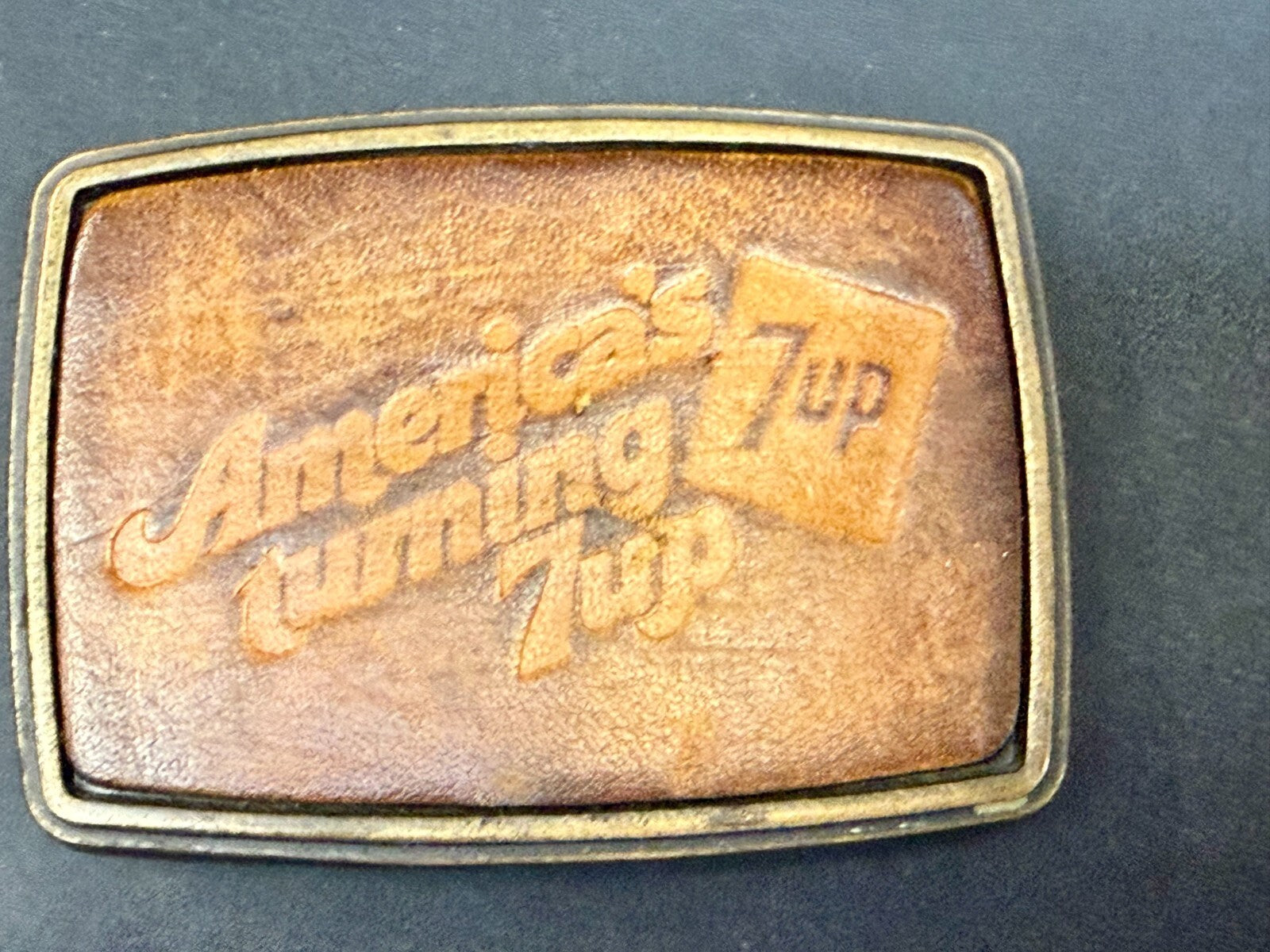 America's Turning 7up Embossed Leather on Metal Advertising Promo Belt Buckle