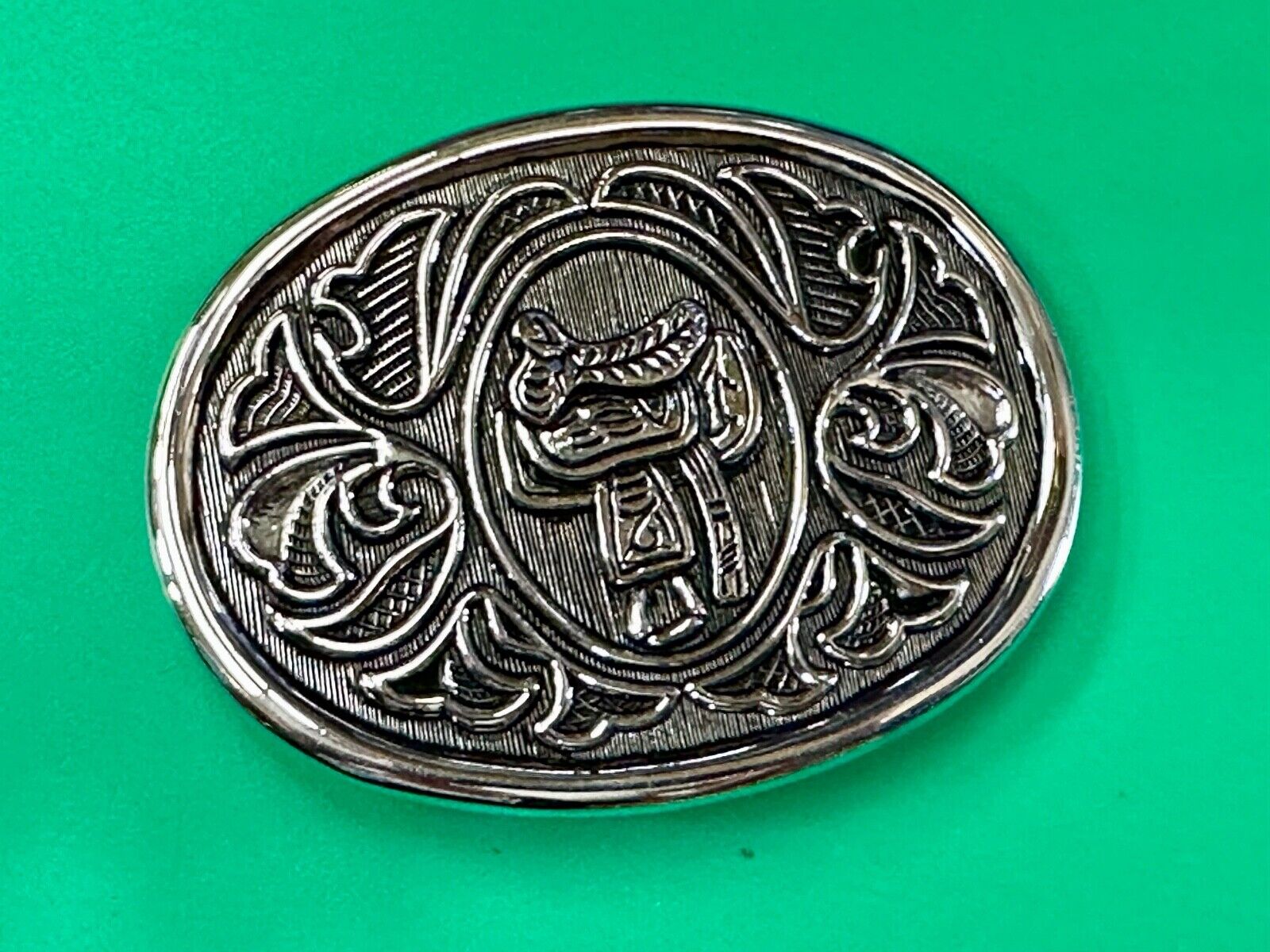 Vintage Cowboy's Horse Saddle ornate flower swirl oval belt buckle by Avon