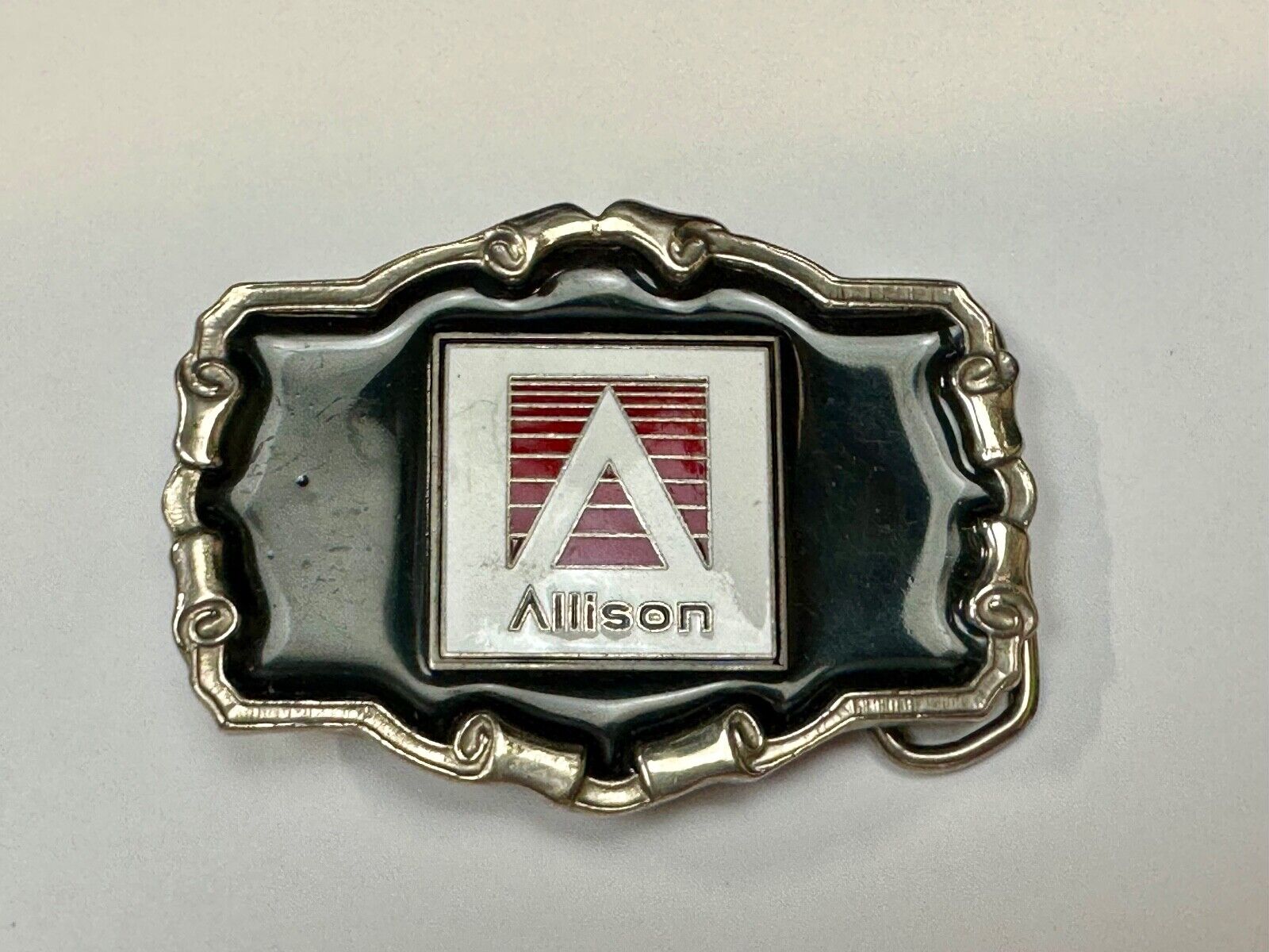 Allison Company logo emblem on western framed black enameled belt buckle
