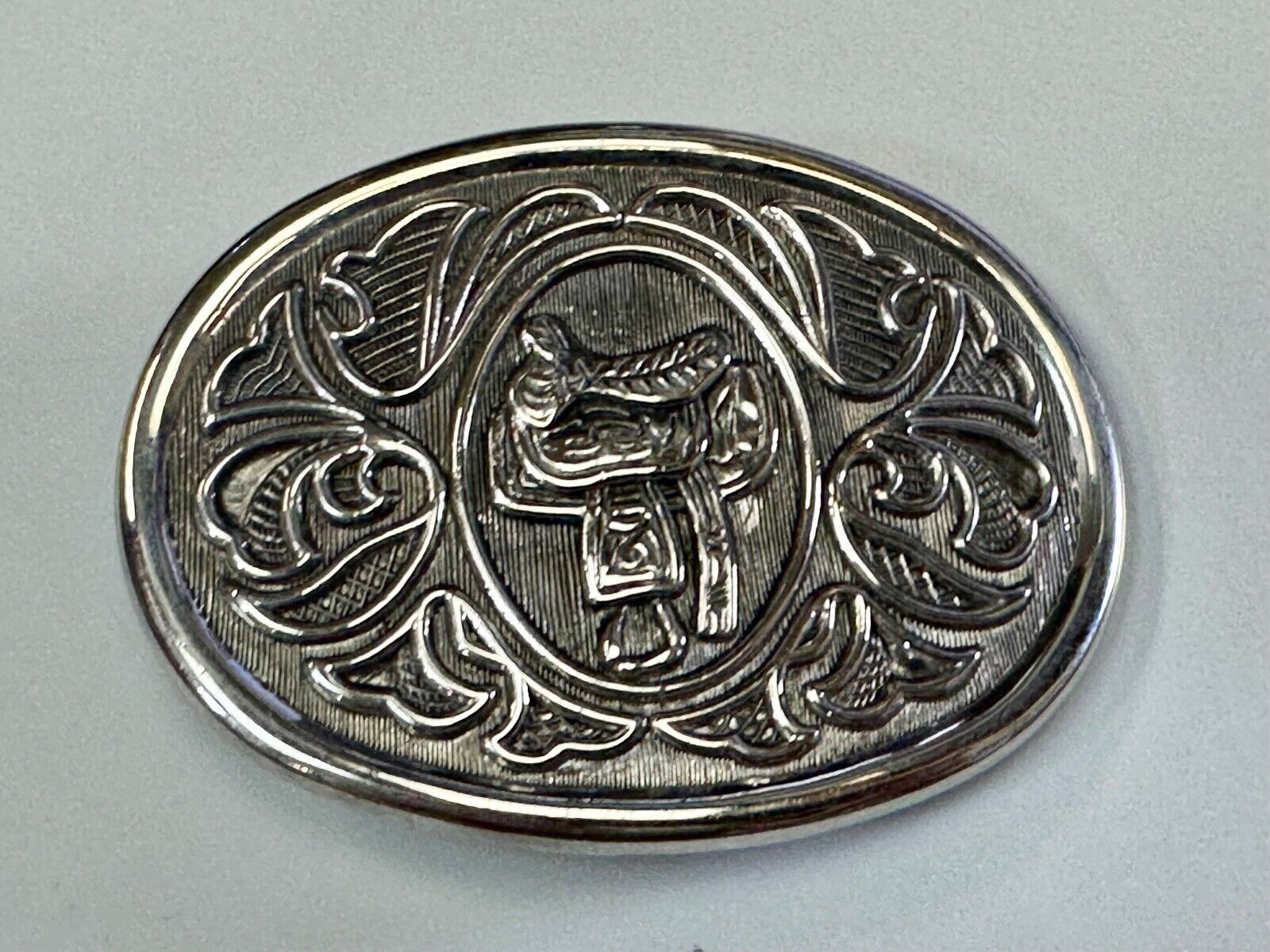 Vintage Cowboy's Horse Saddle ornate flower swirl oval belt buckle by Avon