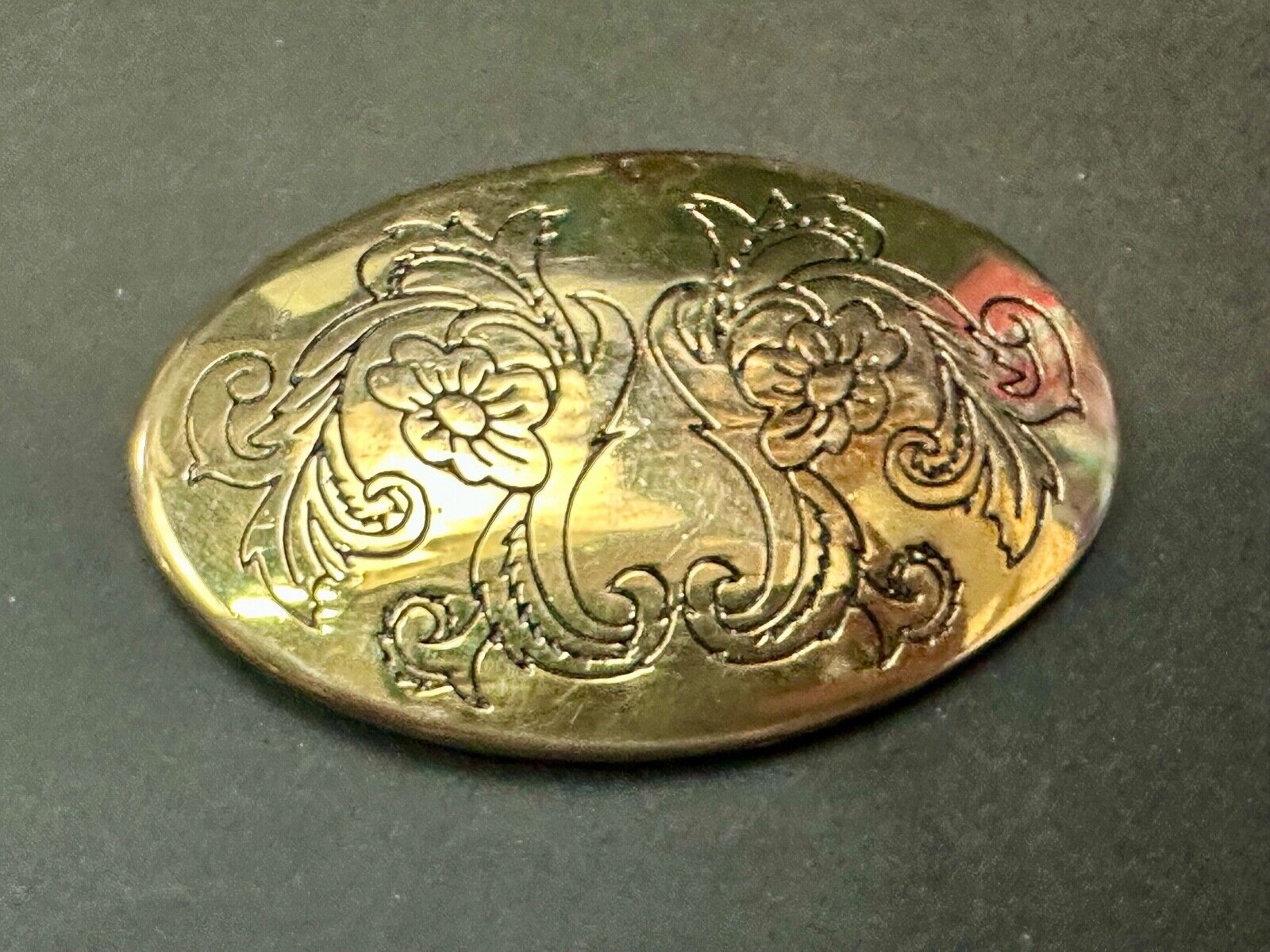Antique? Engraved flower swirl pattern on gold color oval belt buckle