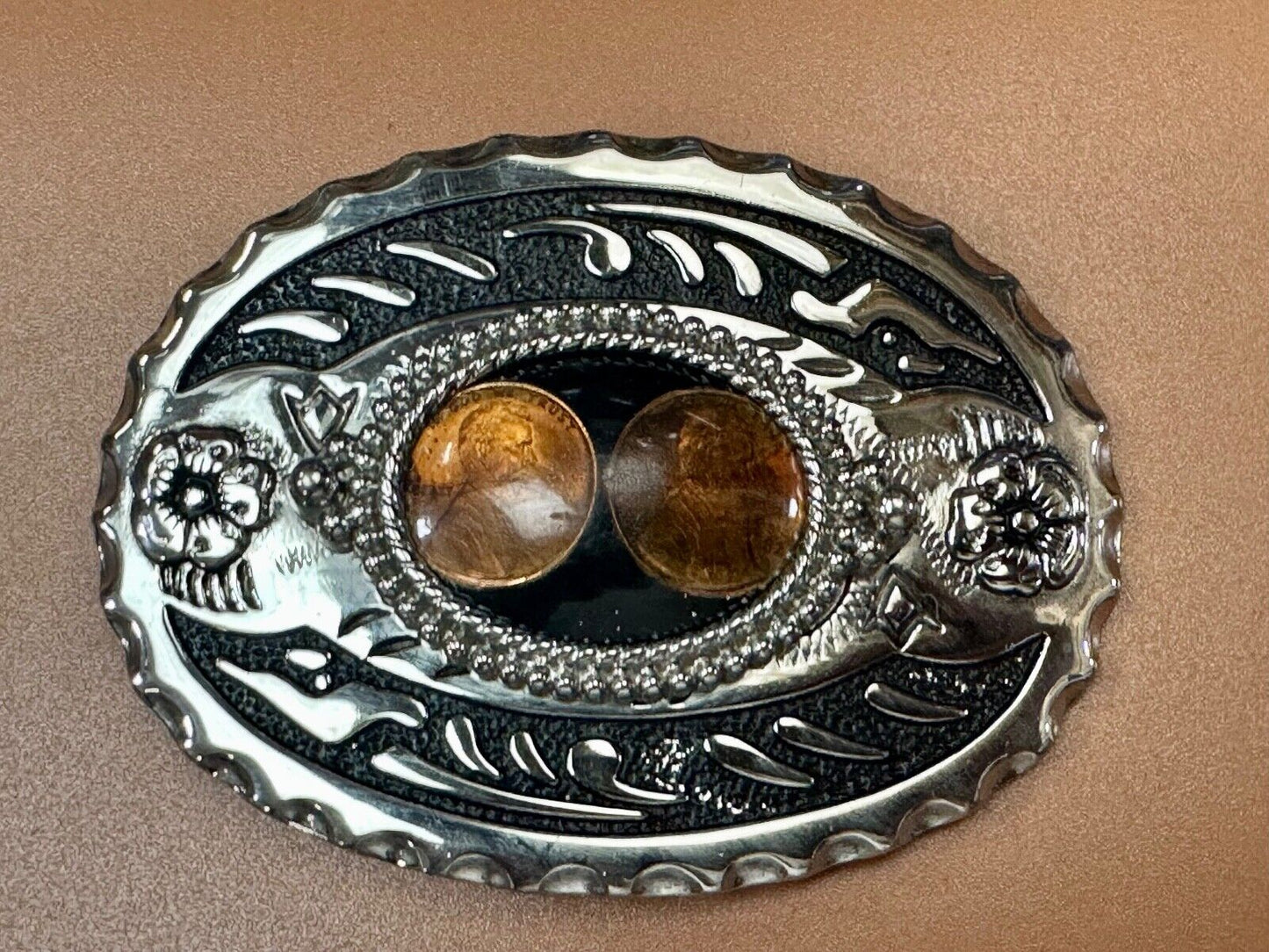 Two lucky pennies coins encased in cab style centerpiece of western belt buckle