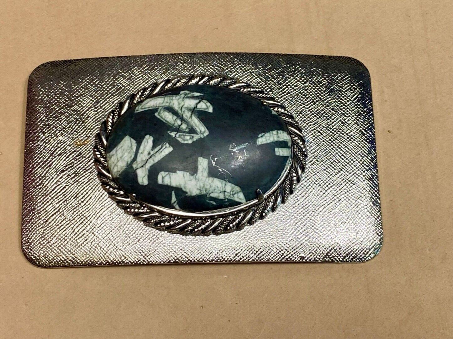 Black & white Oval Cabochon Conch centerpiece on Western belt buckle