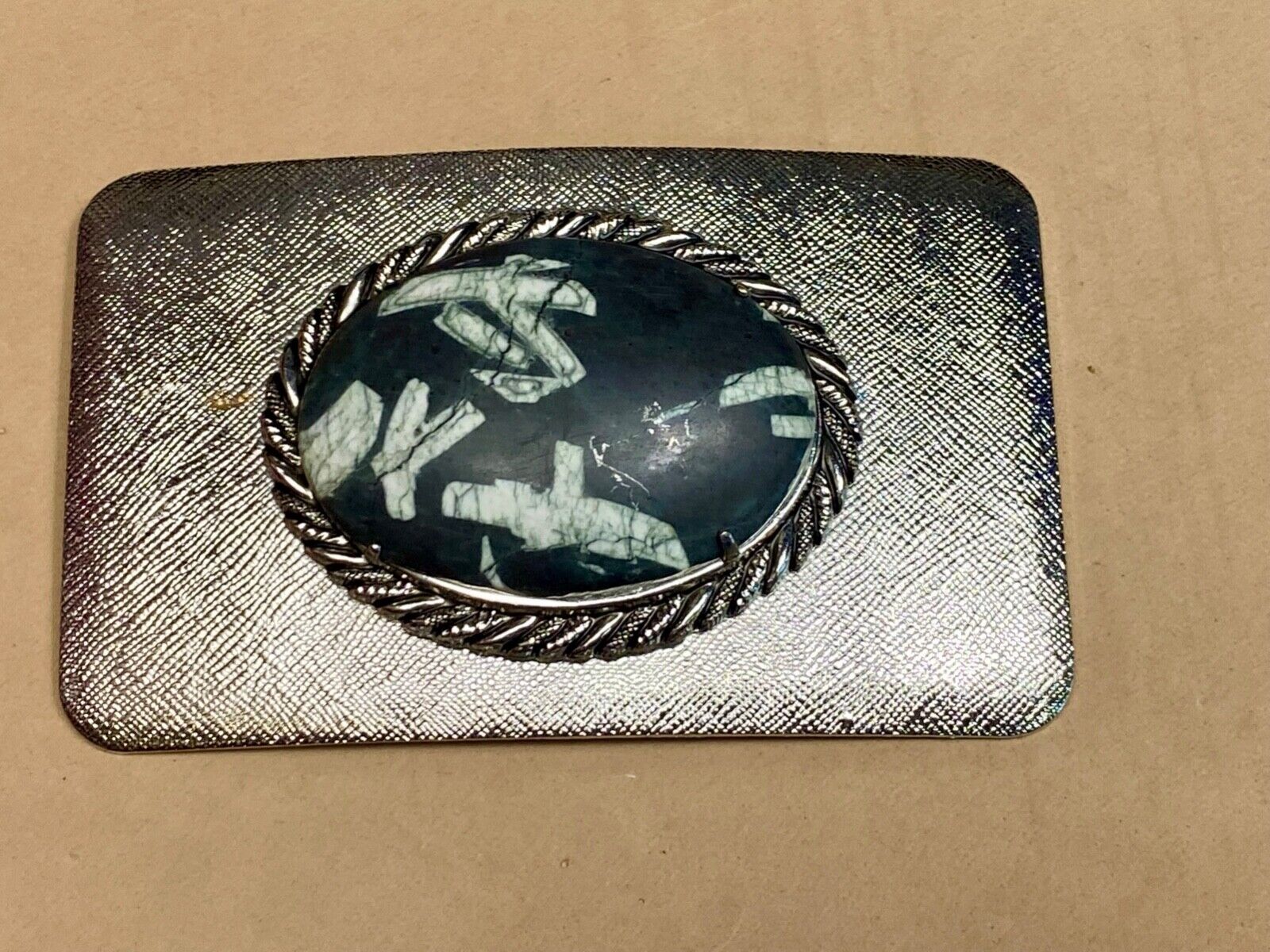 Black & white Oval Cabochon Conch centerpiece on Western belt buckle