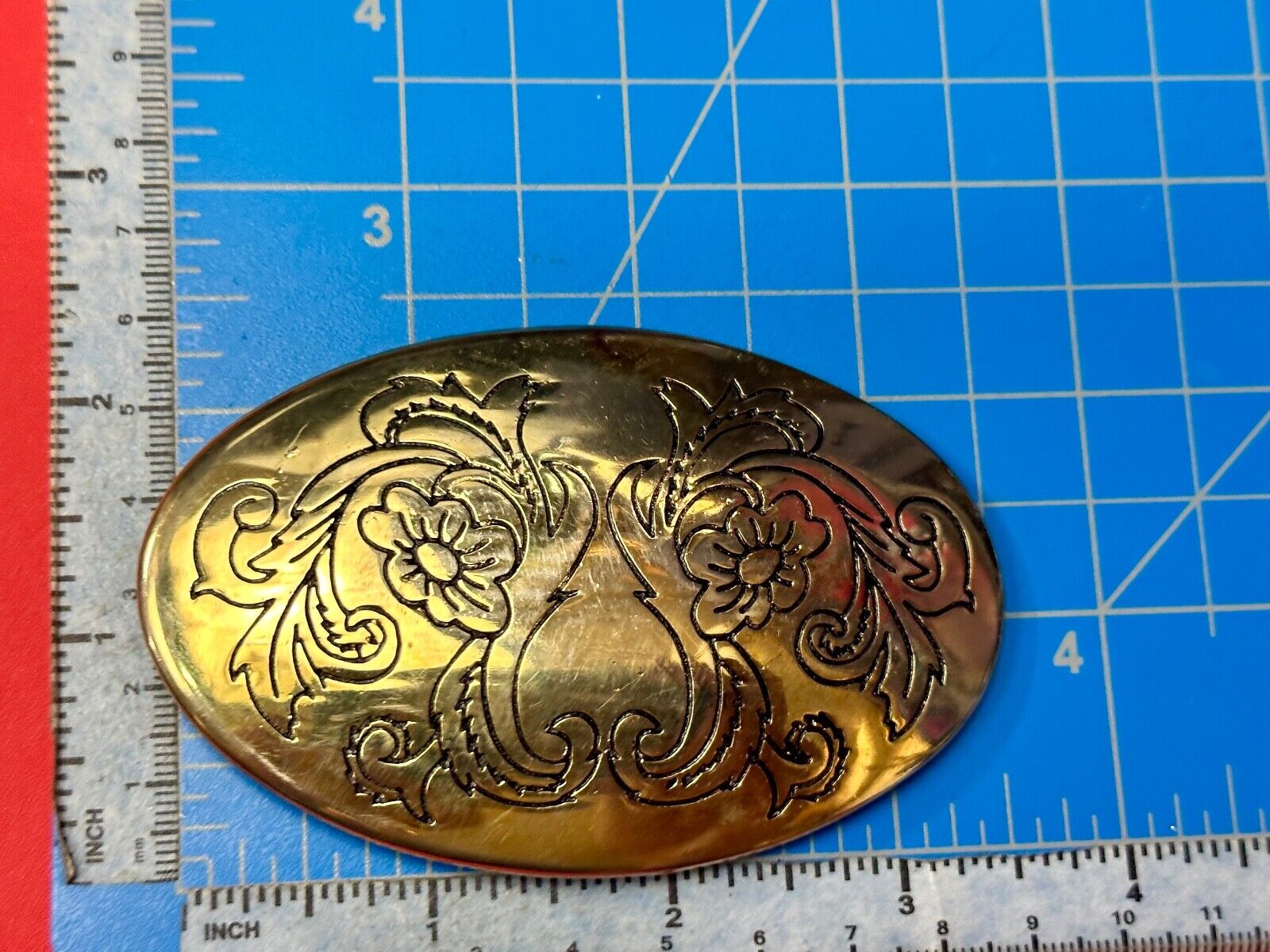 Antique? Engraved flower swirl pattern on gold color oval belt buckle
