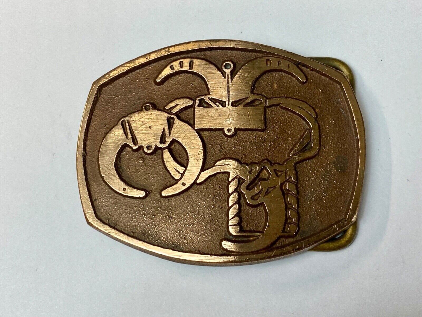 unknown to me - cattle branding symbols? longhorn western? belt buckle