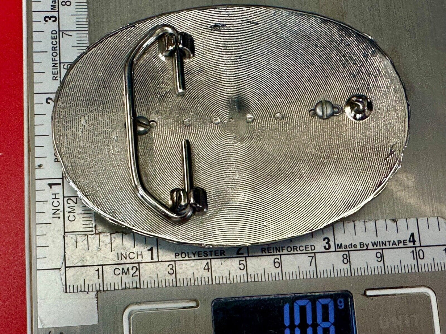 Two lucky pennies coins encased in cab style centerpiece of western belt buckle
