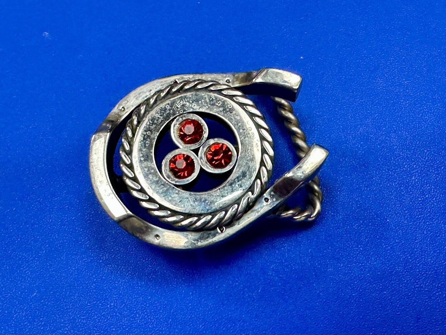 artisan circle pattern rope centerpiece red dots horseshoe shaped belt buckle
