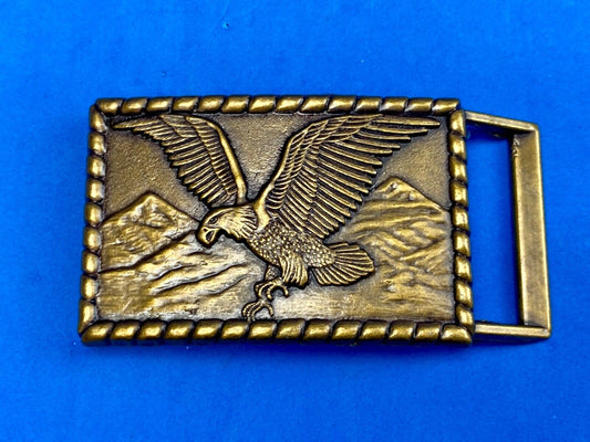 Vintage flying, hunting, fishing American eagle belt buckle with western boarder