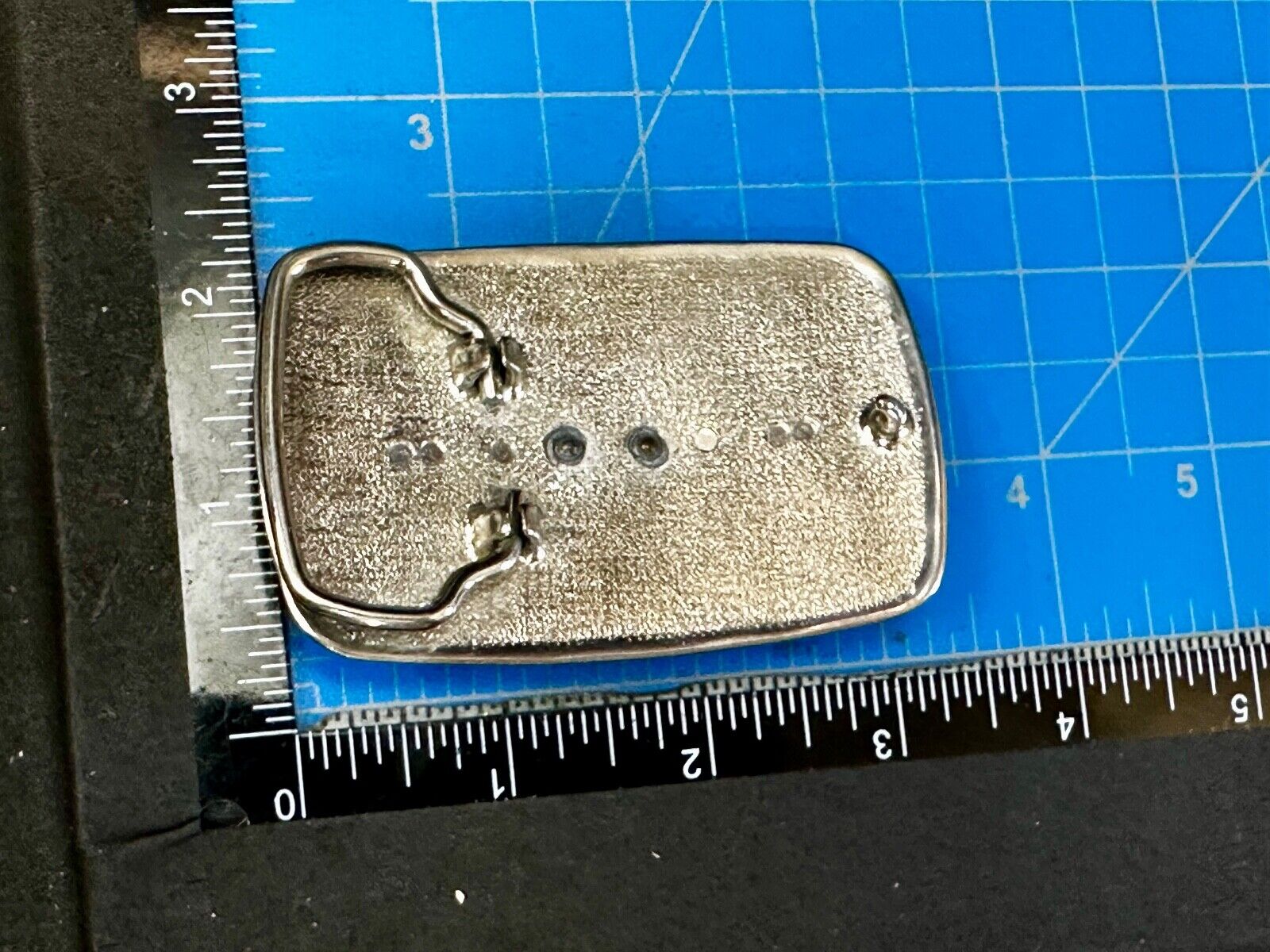 Vintage Cowboy on Saddle Bronc Western belt buckle with mesh pattern background