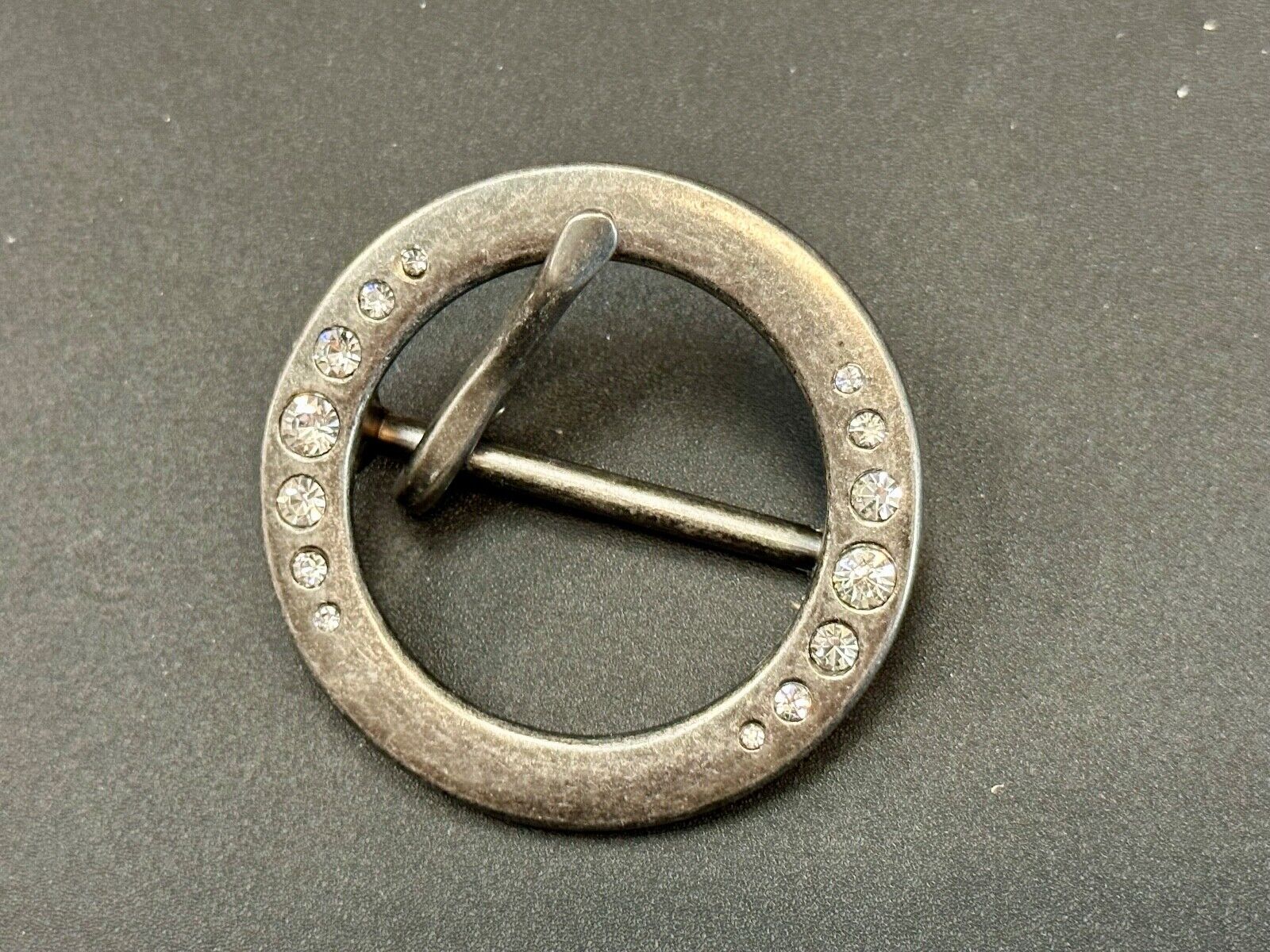2" Round silver tone belt buckle with graduated rhinestone sized