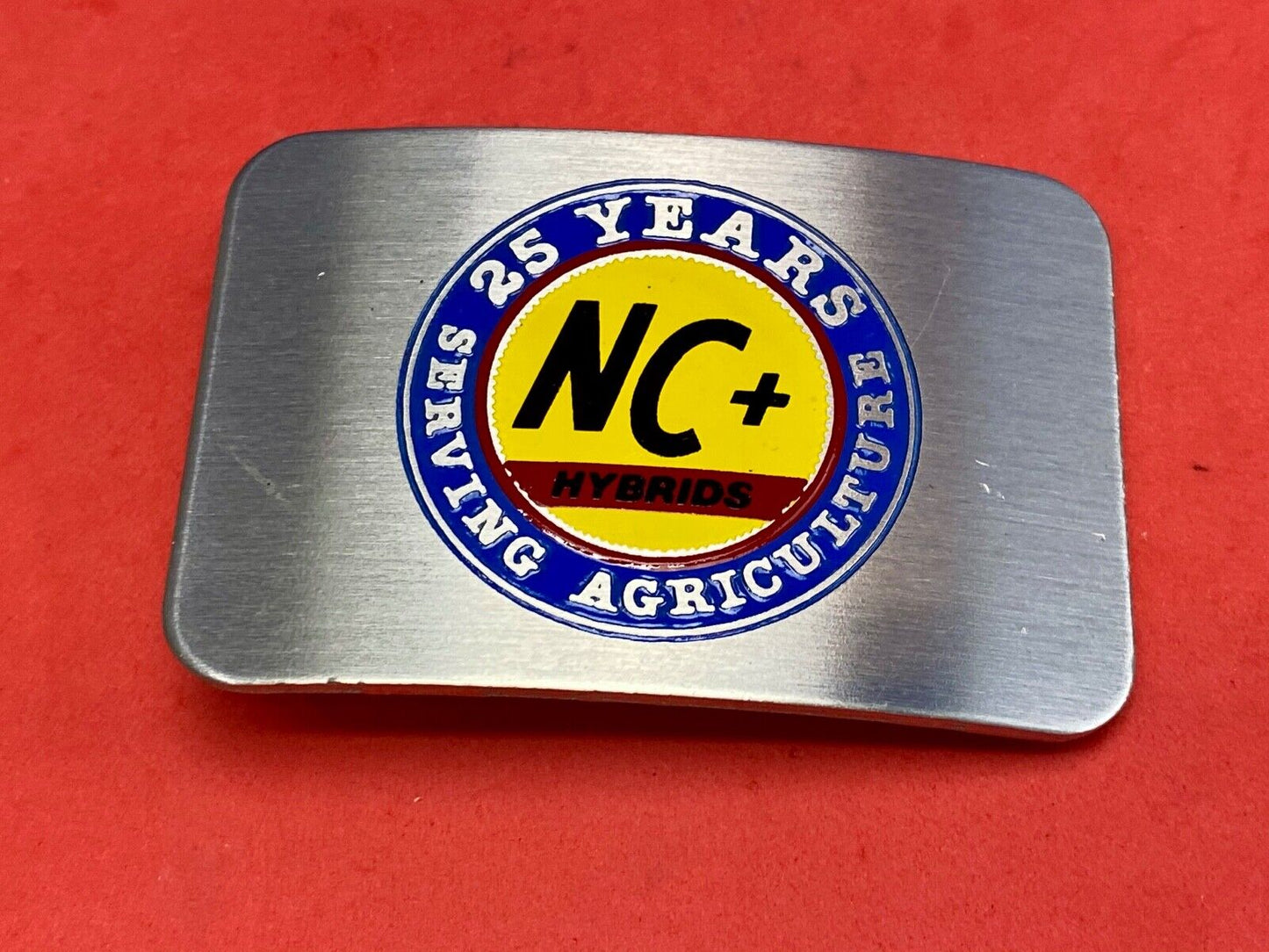 25 years serving agriculture - NC+ Hybrids belt buckle