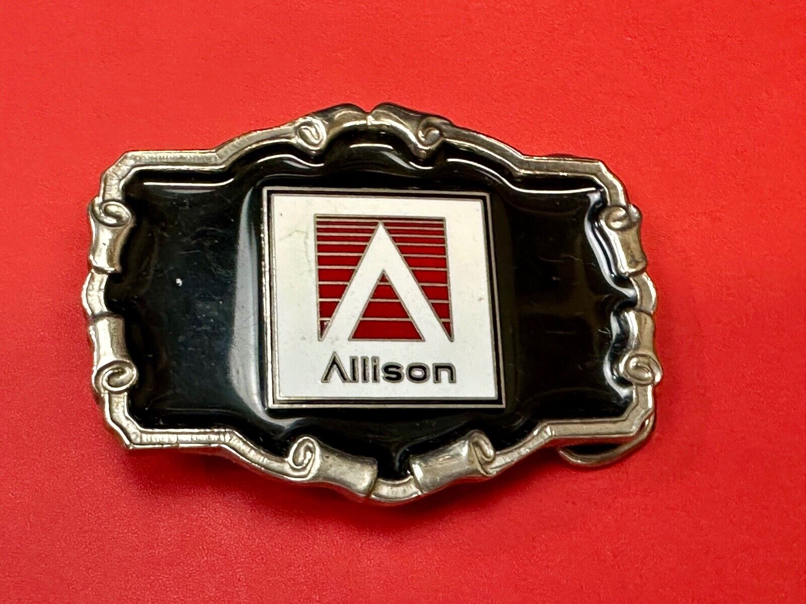 Allison Company logo emblem on western framed black enameled belt buckle