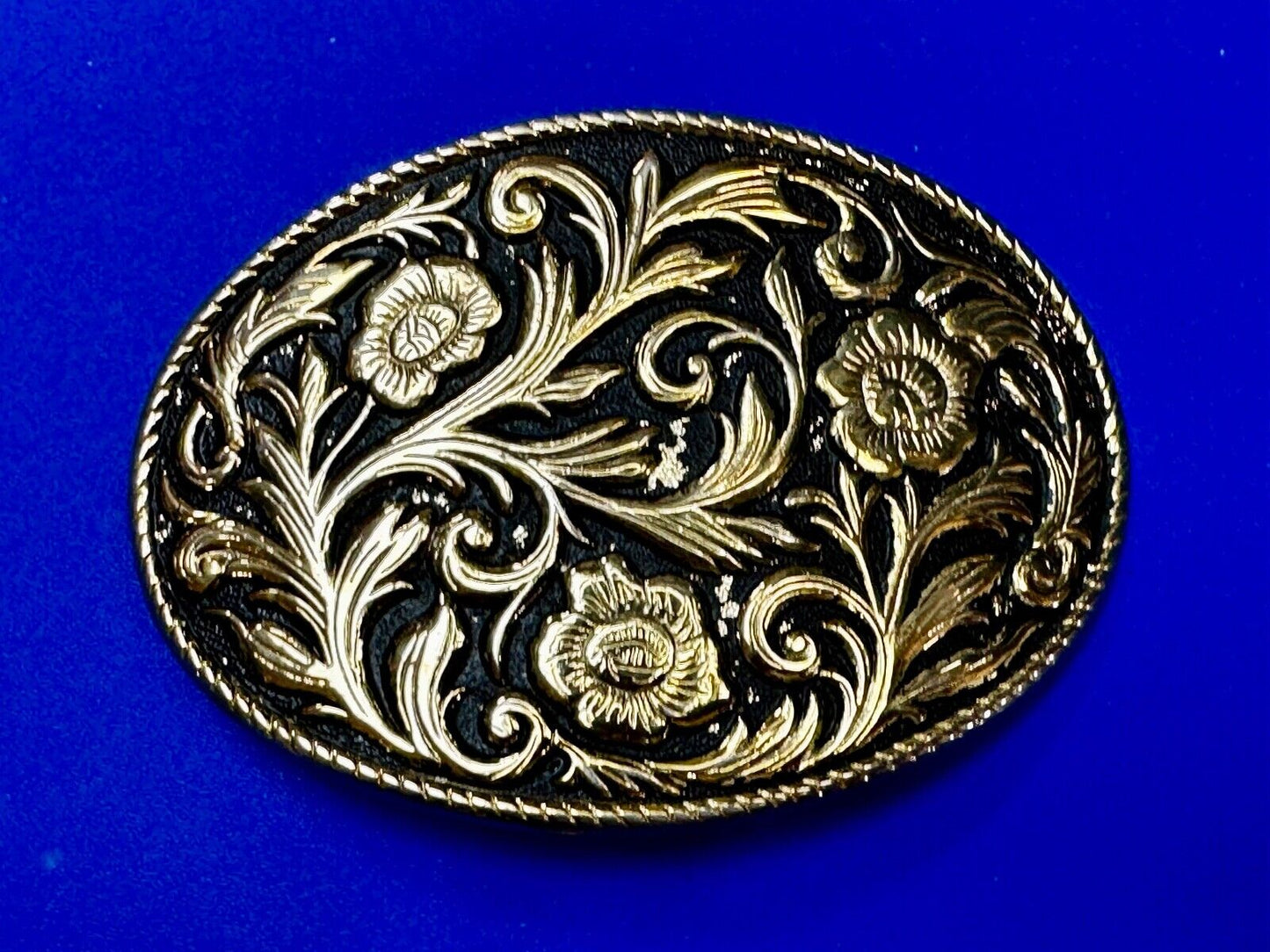 Vintage black and gold tone western flower floral theme cowboys belt buckle