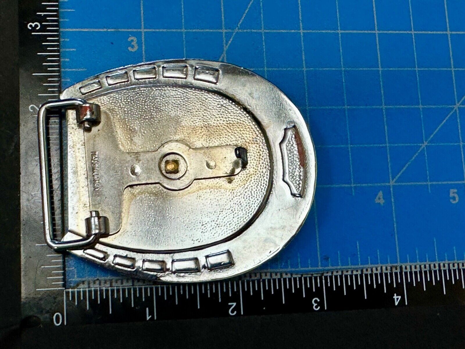 Artisan Resin covered Horseshoe shaped Belt Buckle with gold tone standing horse
