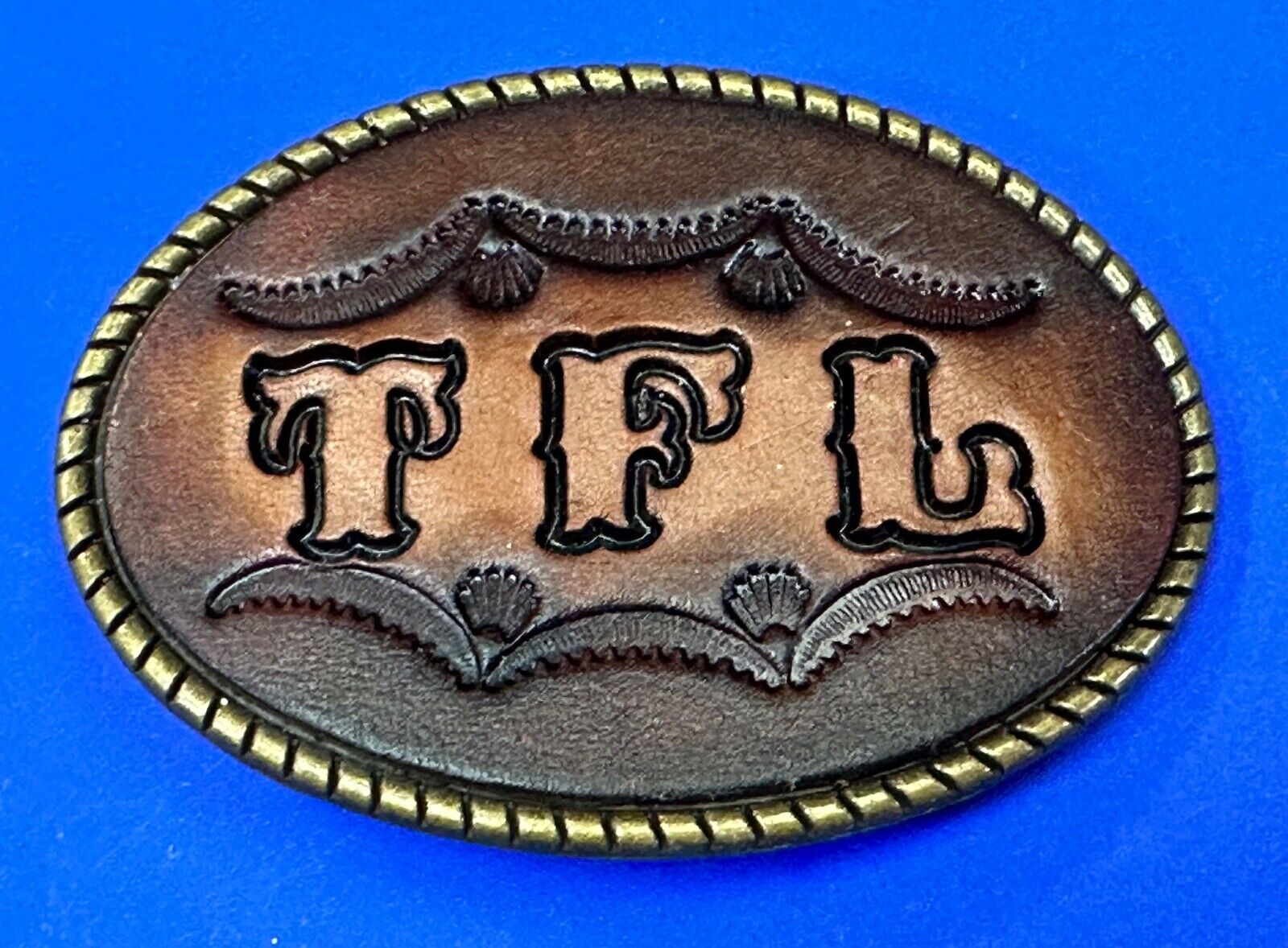 TFL.  vintage western initials letters on leather belt buckle