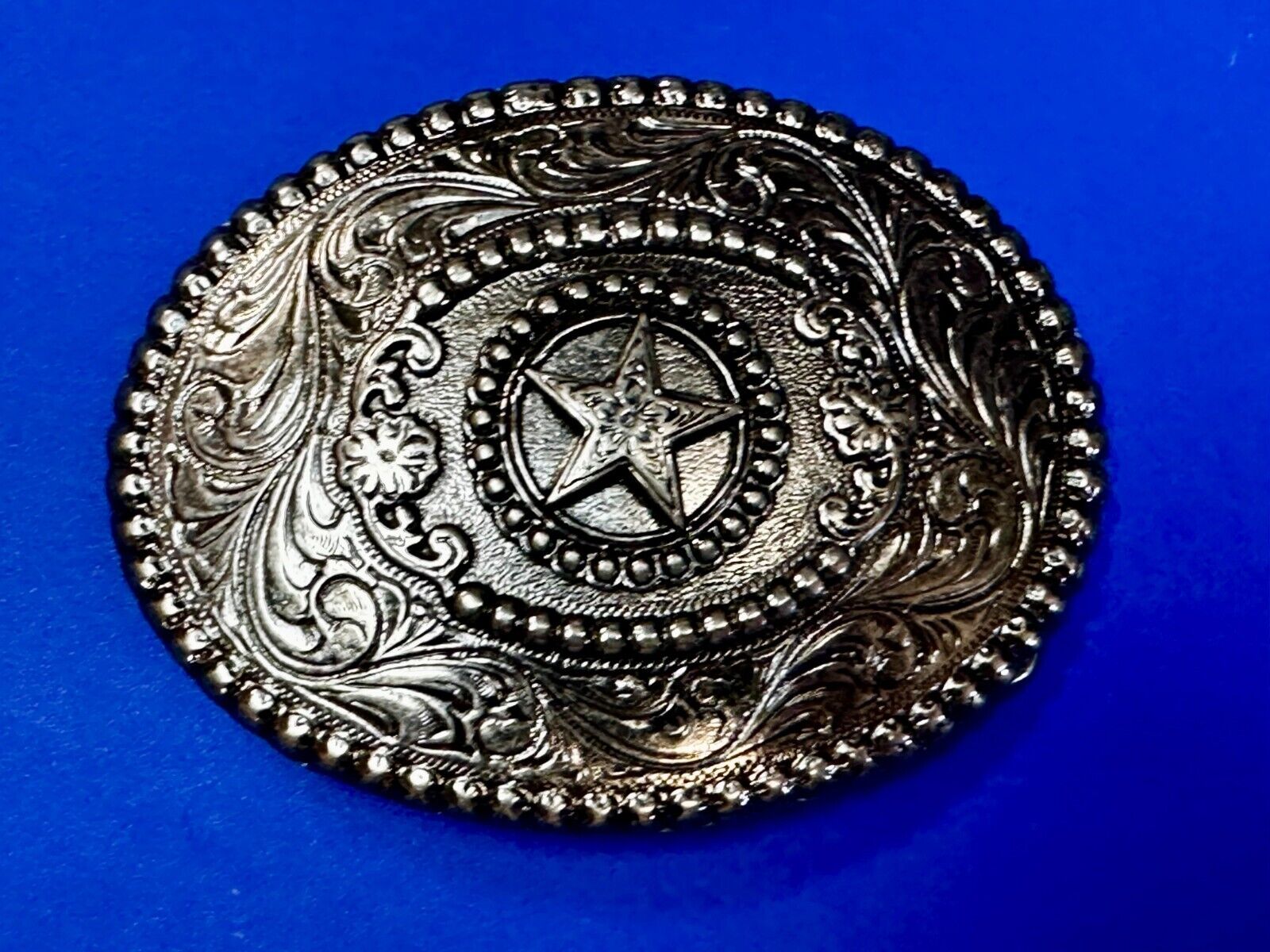 The Lone Star Centered In Oval Flower Swirl Silver Tone Belt Buckle