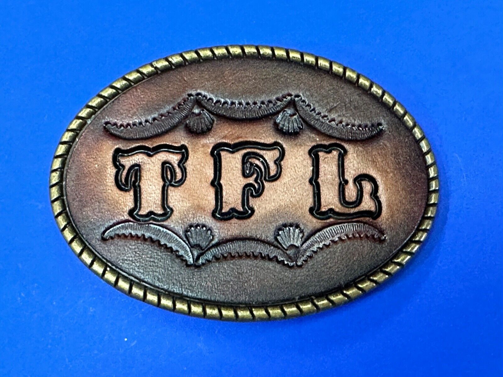TFL.  vintage western initials letters on leather belt buckle