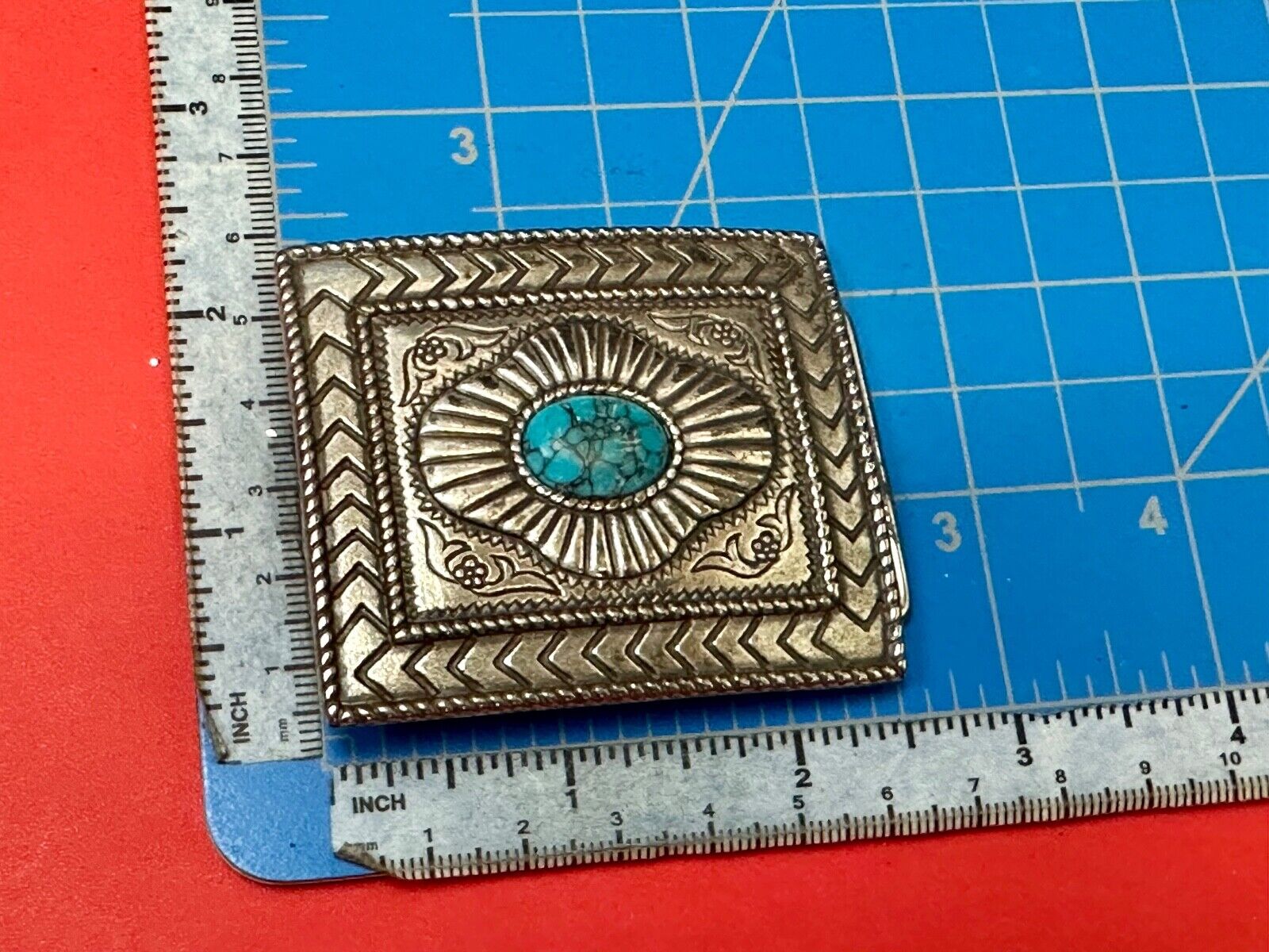 Turquoise Cab centerpiece on southwestern pattern silver tone belt buckle