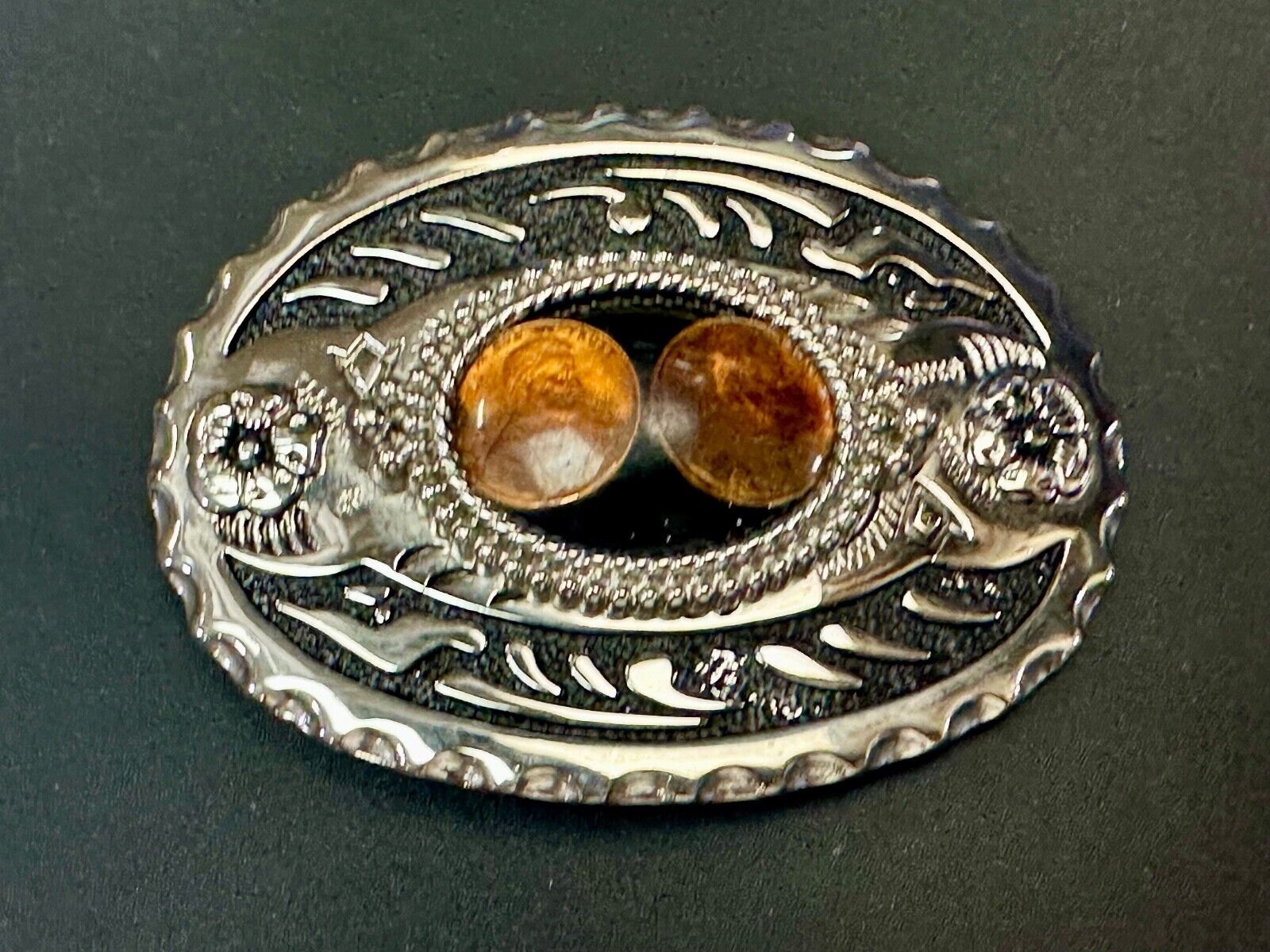 Two lucky pennies coins encased in cab style centerpiece of western belt buckle